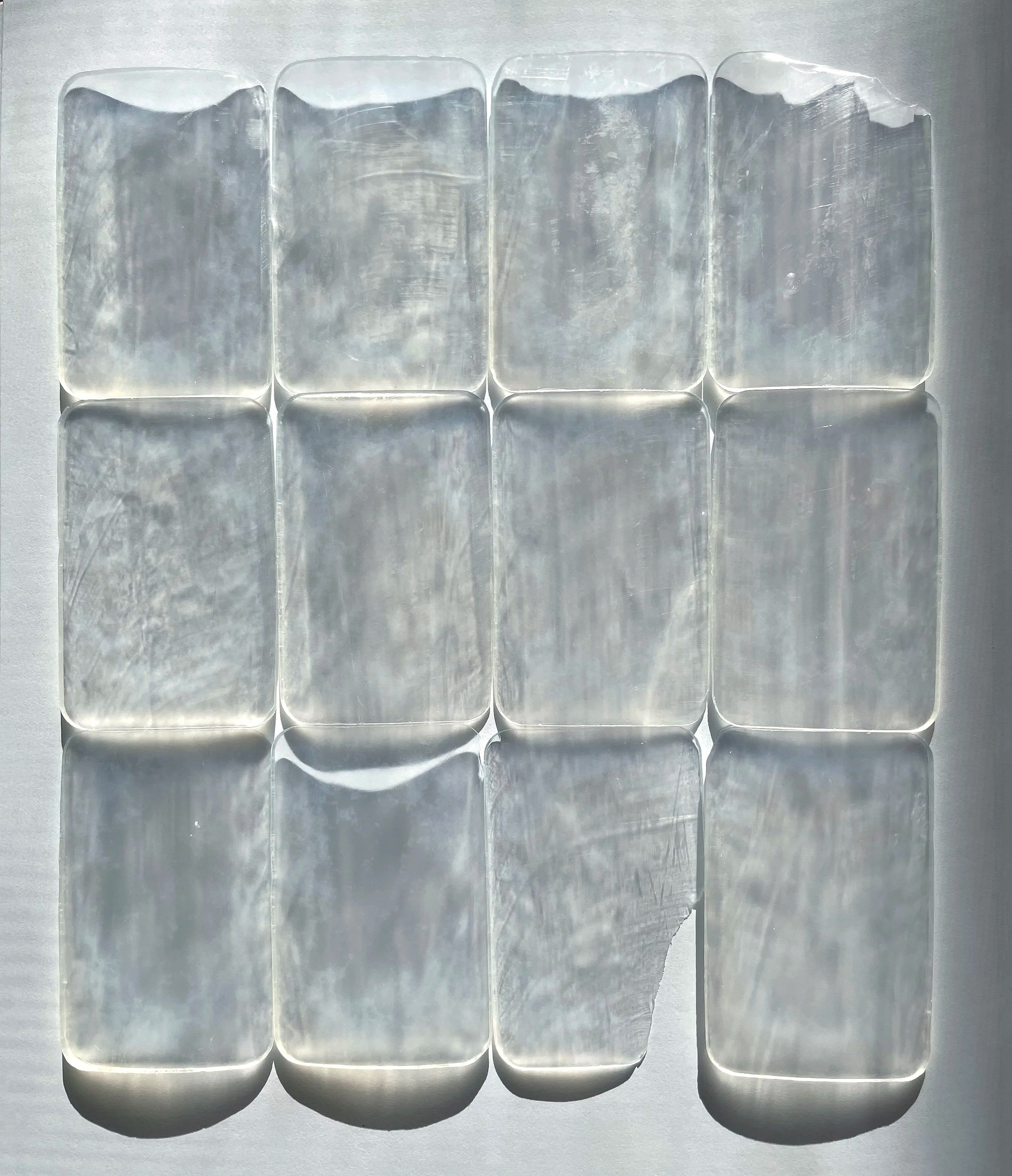 Screens, 2026. Glycerin soap on paper.