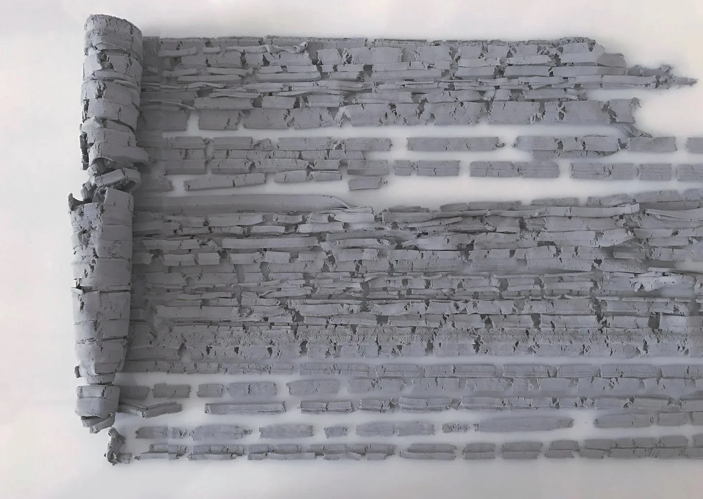 Bricks, 2024. Kneaded eraser on glass.