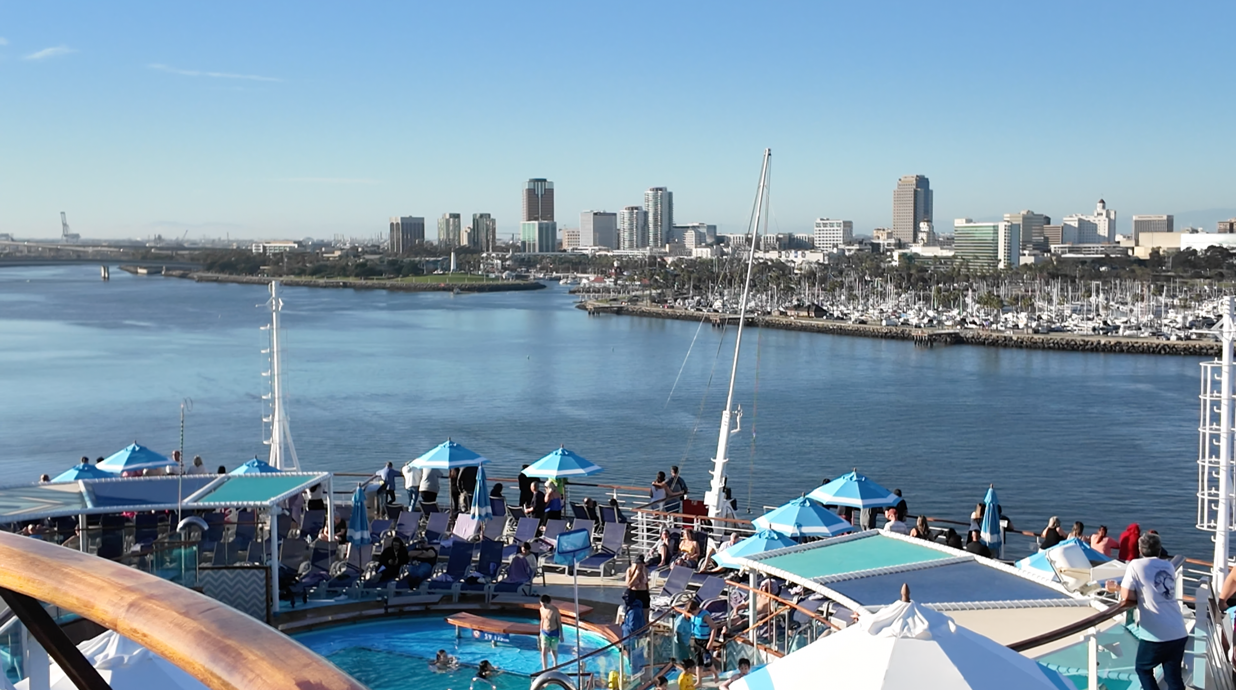 Passengers enjoying a lively cruise ship pool deck during a short cruise