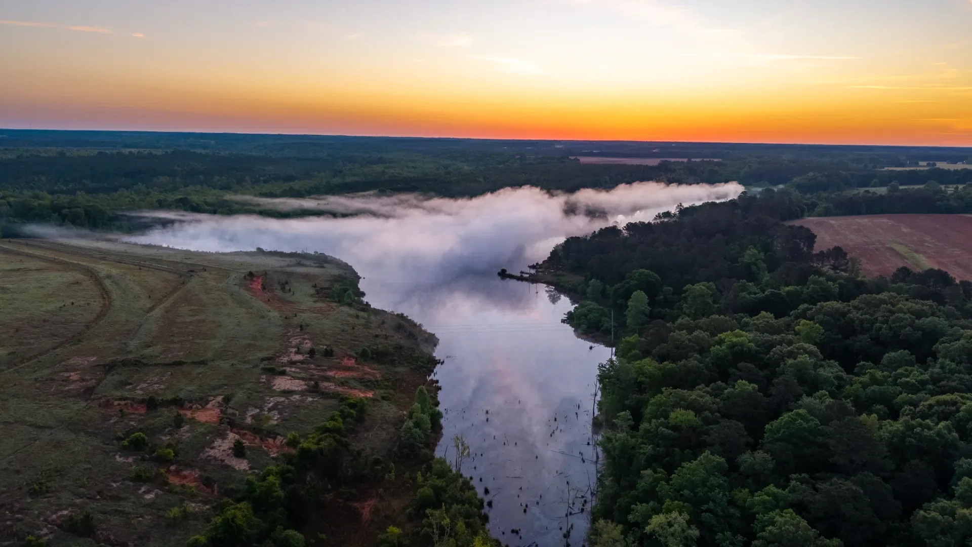 An aerial view of the Shivers Farm property, including a sunrise and pond