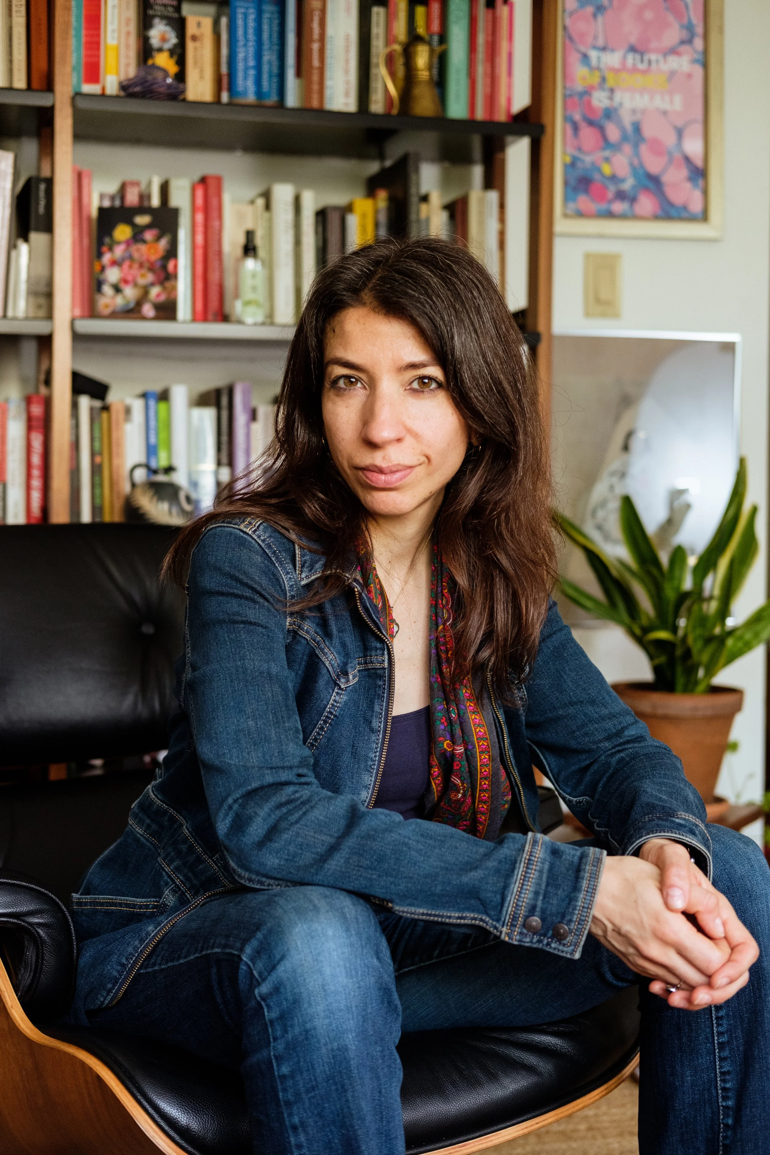 Portrait of woman in front of bookshelf