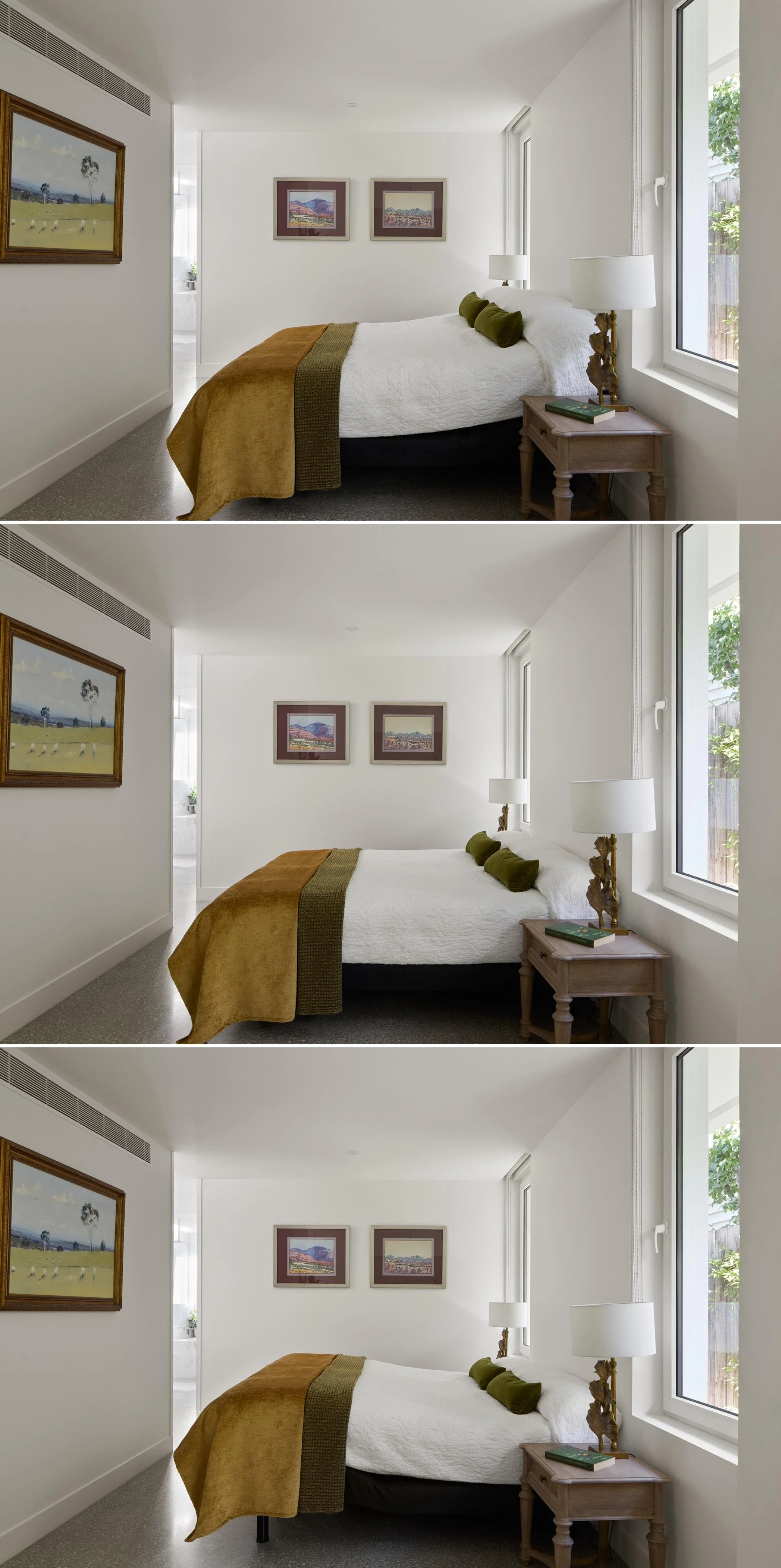 A bedroom with a bed, pillows, side table, lamp, and wall art, featuring three nearly identical angles of the same scene.