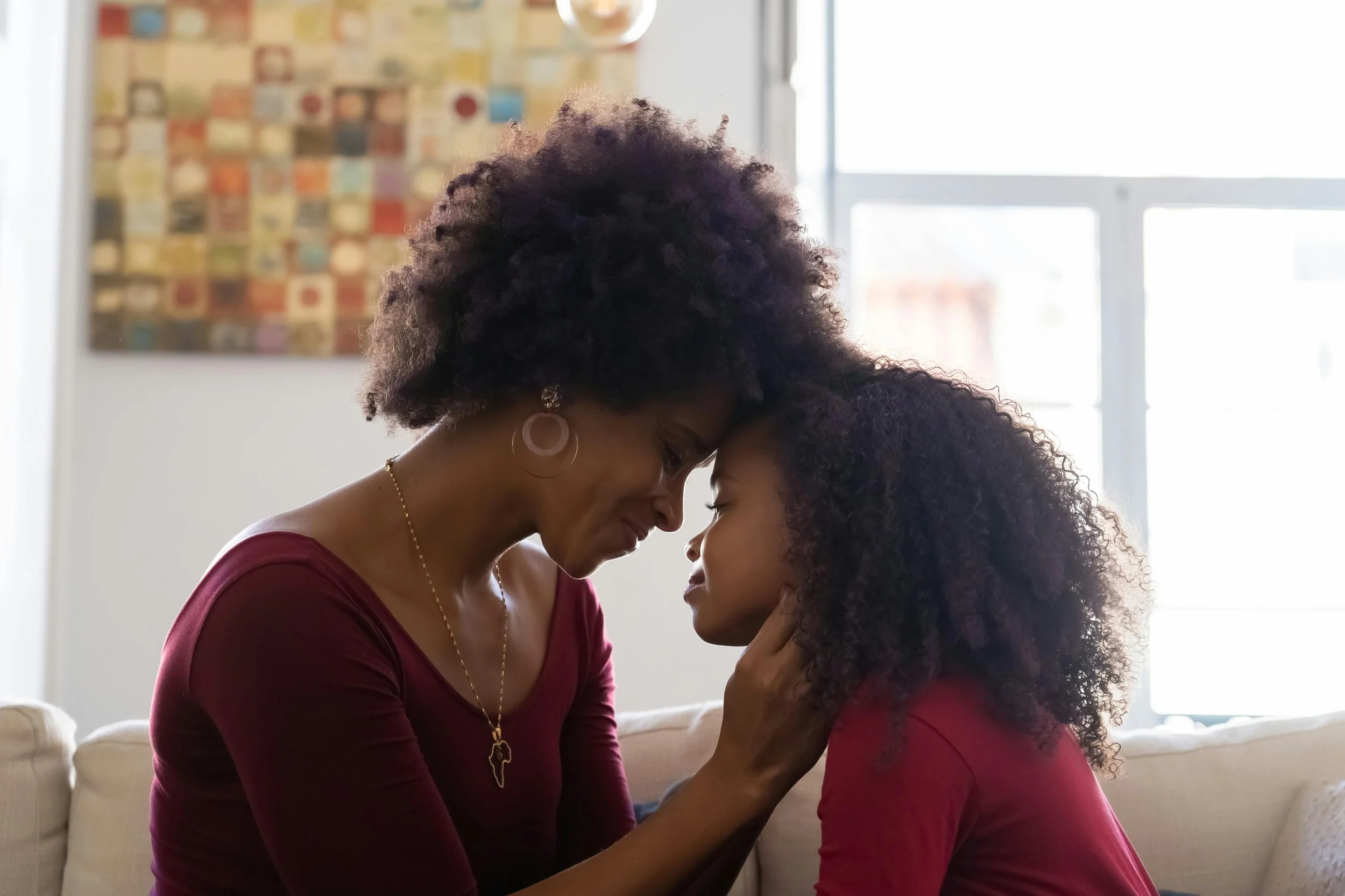 A confident mother enjoying time with her daughter who has ADHD, autism, or PDA.