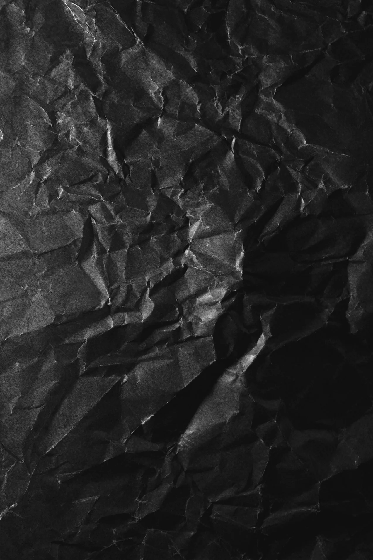 Crumpled black paper with textured surface.