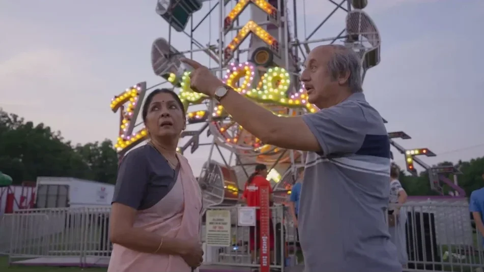 A man and woman having a conversation at an amusement park with a large, colorful Ferris wheel in the background.