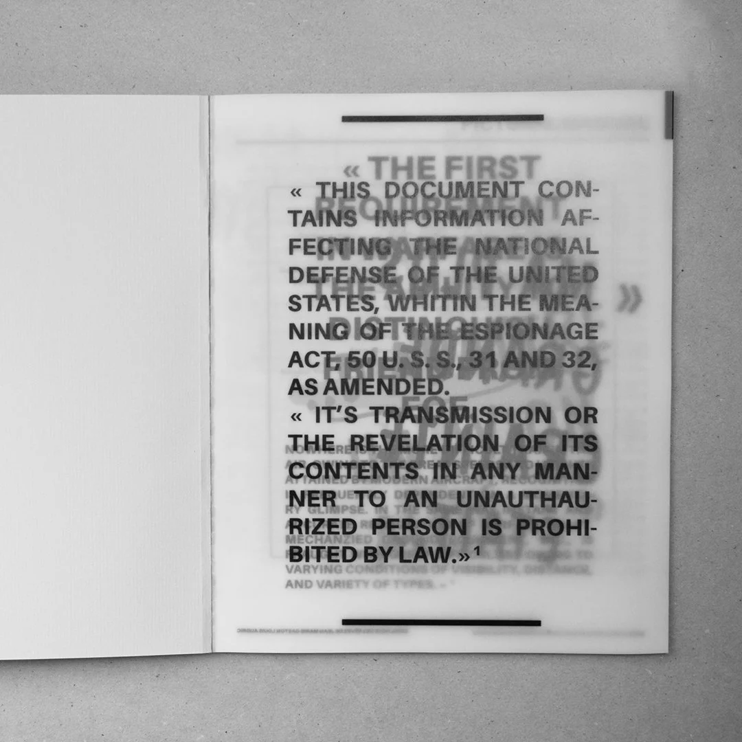Un livre ouvert avec un texte en anglais sur la défense nationale des États-Unis, en noir et blanc.
