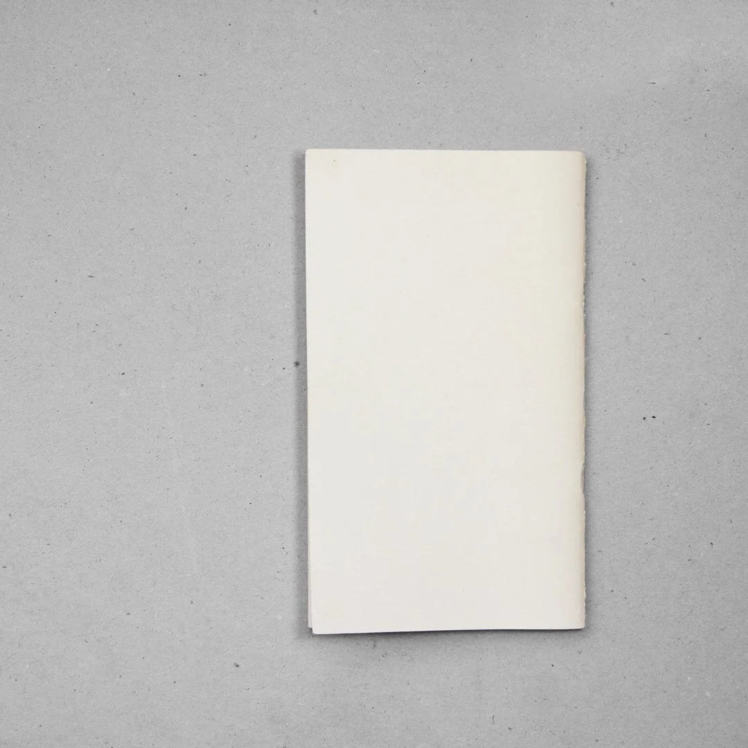 Une feuille de papier blanc posée sur un fond gris.