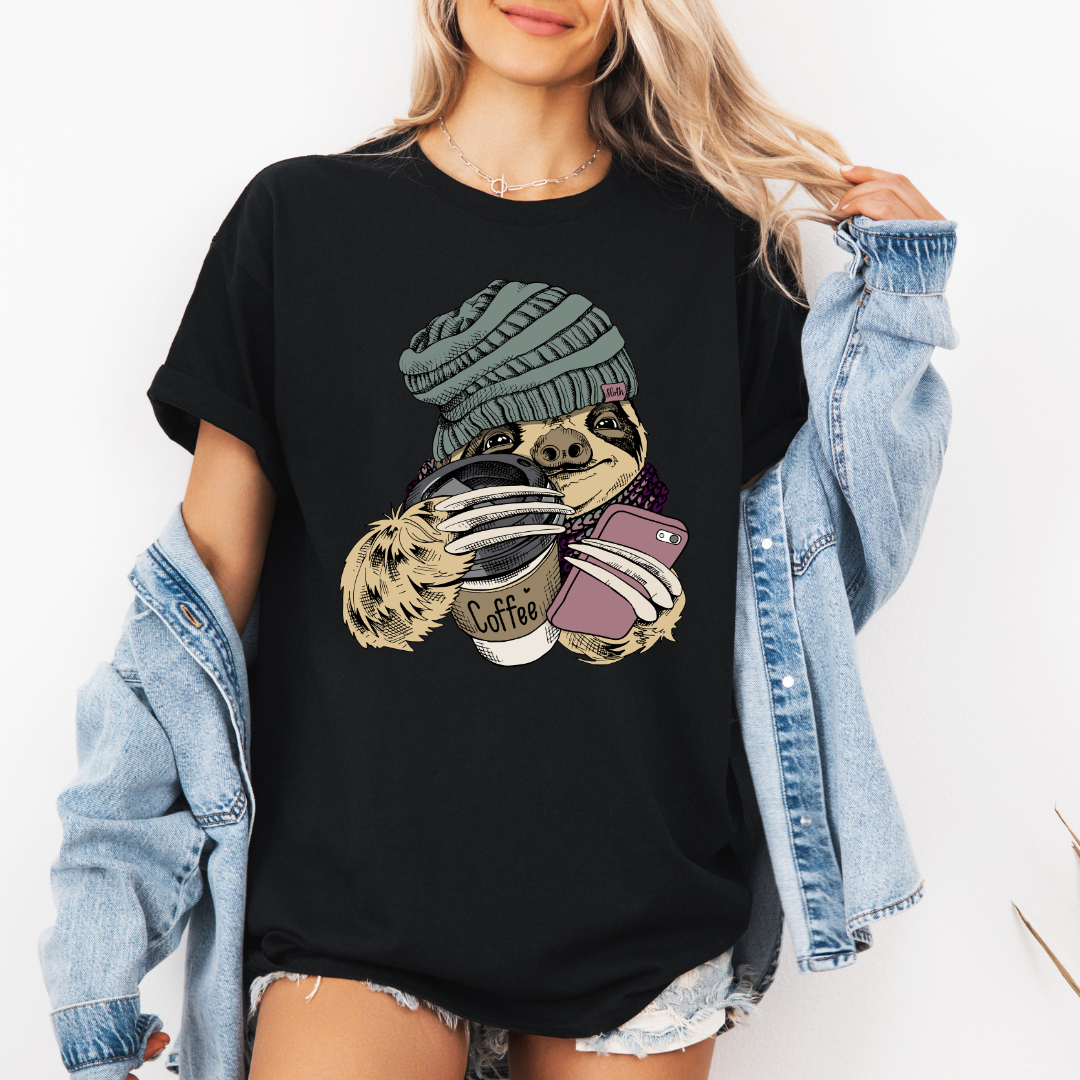 Female Model wearing a black Cozy Coffee Sloth soft graphic t-shirt, showcasing its unique design and comfortable fit from Coffee and Moo.