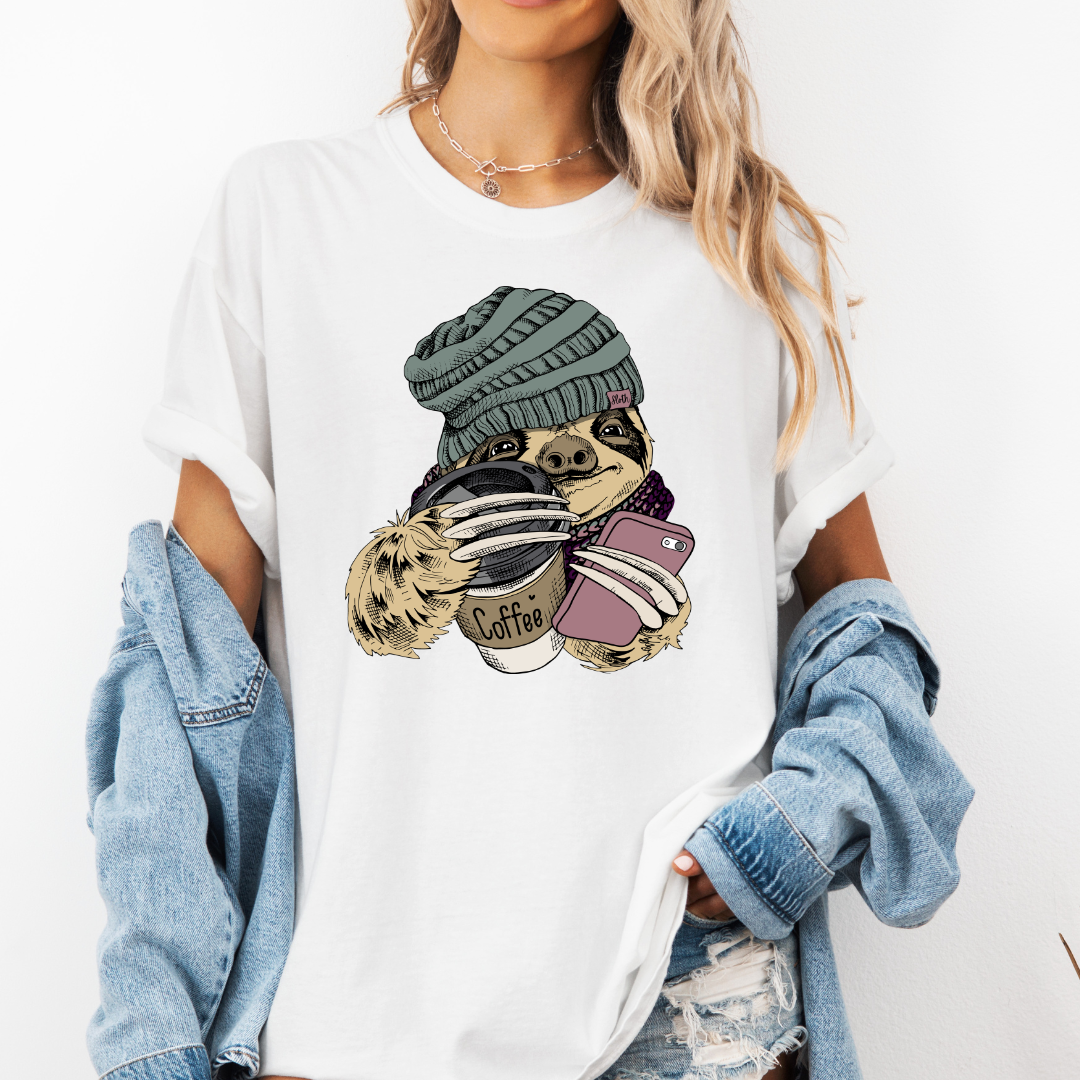 Female Model wearing a white Cozy Coffee Sloth soft graphic t-shirt, showcasing its unique design and comfortable fit from Coffee and Moo.