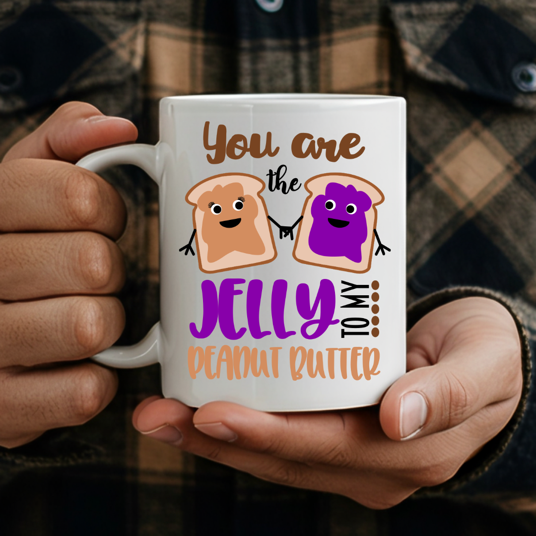 Male holding one mug from the Peanut Butter & Jelly humorous coffee mug set, showcasing the design, by Coffee and Moo.