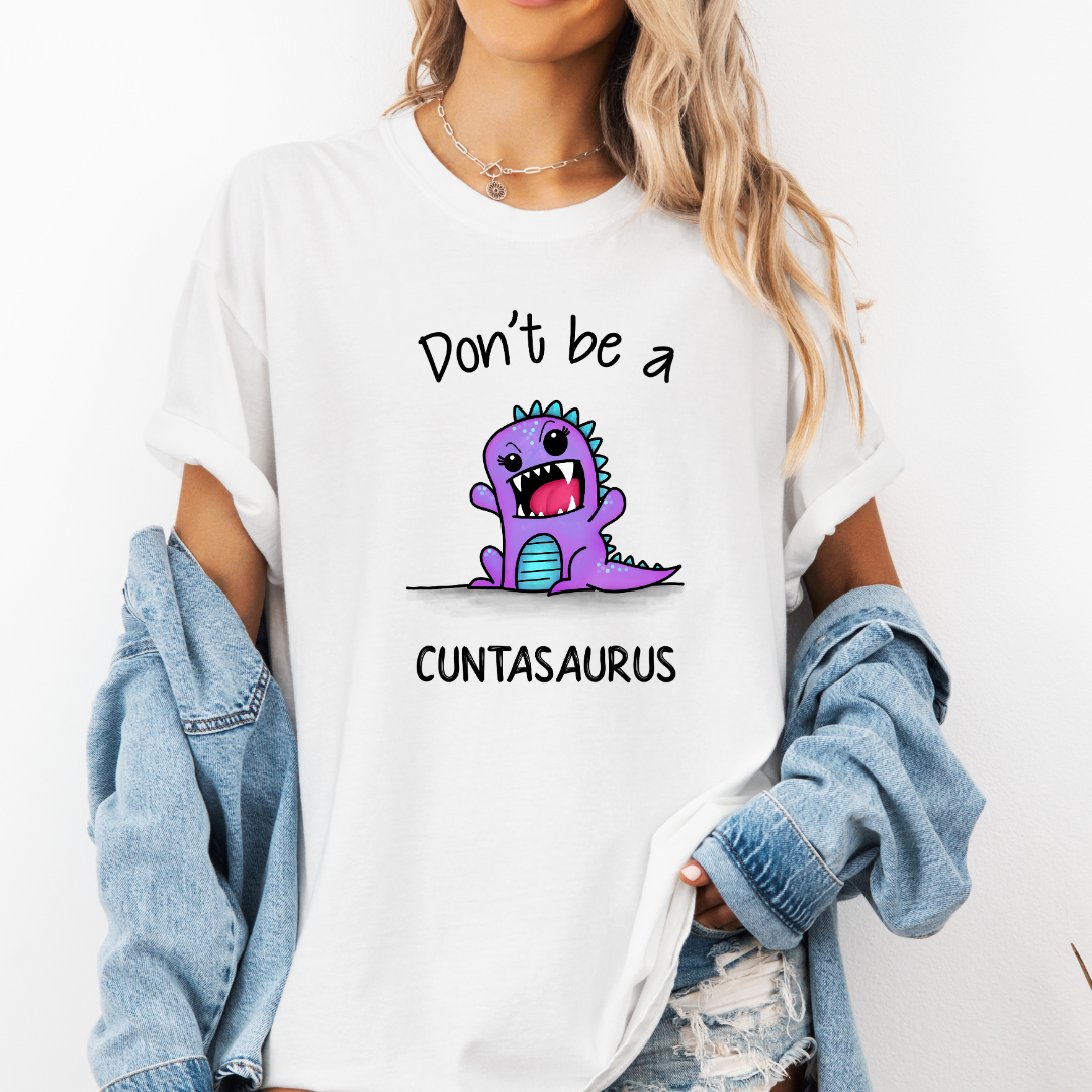 Female Model wearing a white Don’t Be a Cuntasaurus Funny Dinosaur soft graphic t-shirt, showcasing its unique design and comfortable fit from Coffee and Moo.