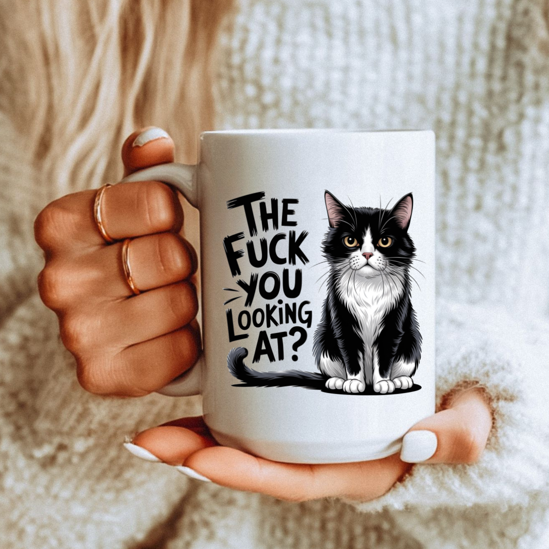 Female holding 15oz mug The Fuck You Looking At Cat unique coffee mug, highlighting "The fuck you looking at?" design, from Coffee and Moo.