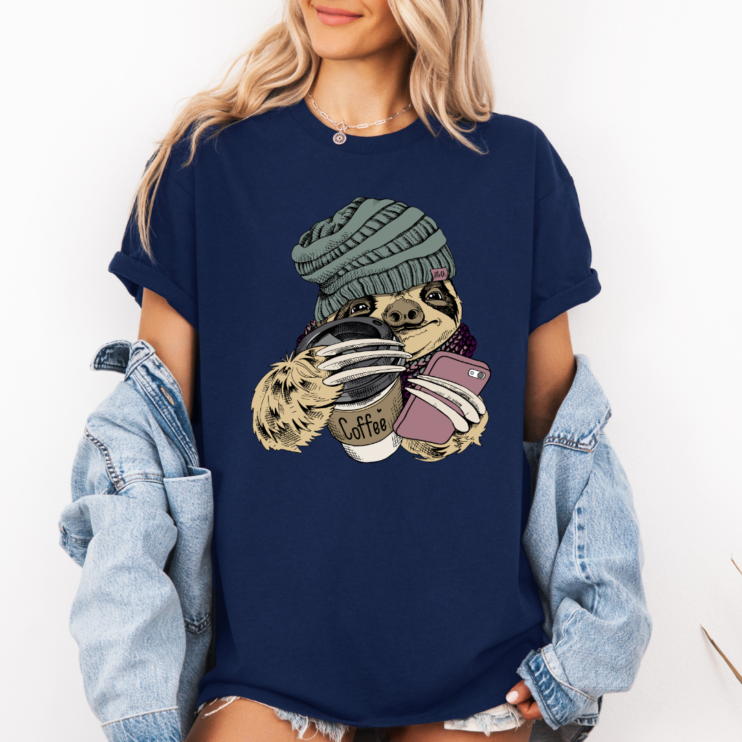 Female Model wearing a navy Cozy Coffee Sloth soft graphic t-shirt, showcasing its unique design and comfortable fit from Coffee and Moo.