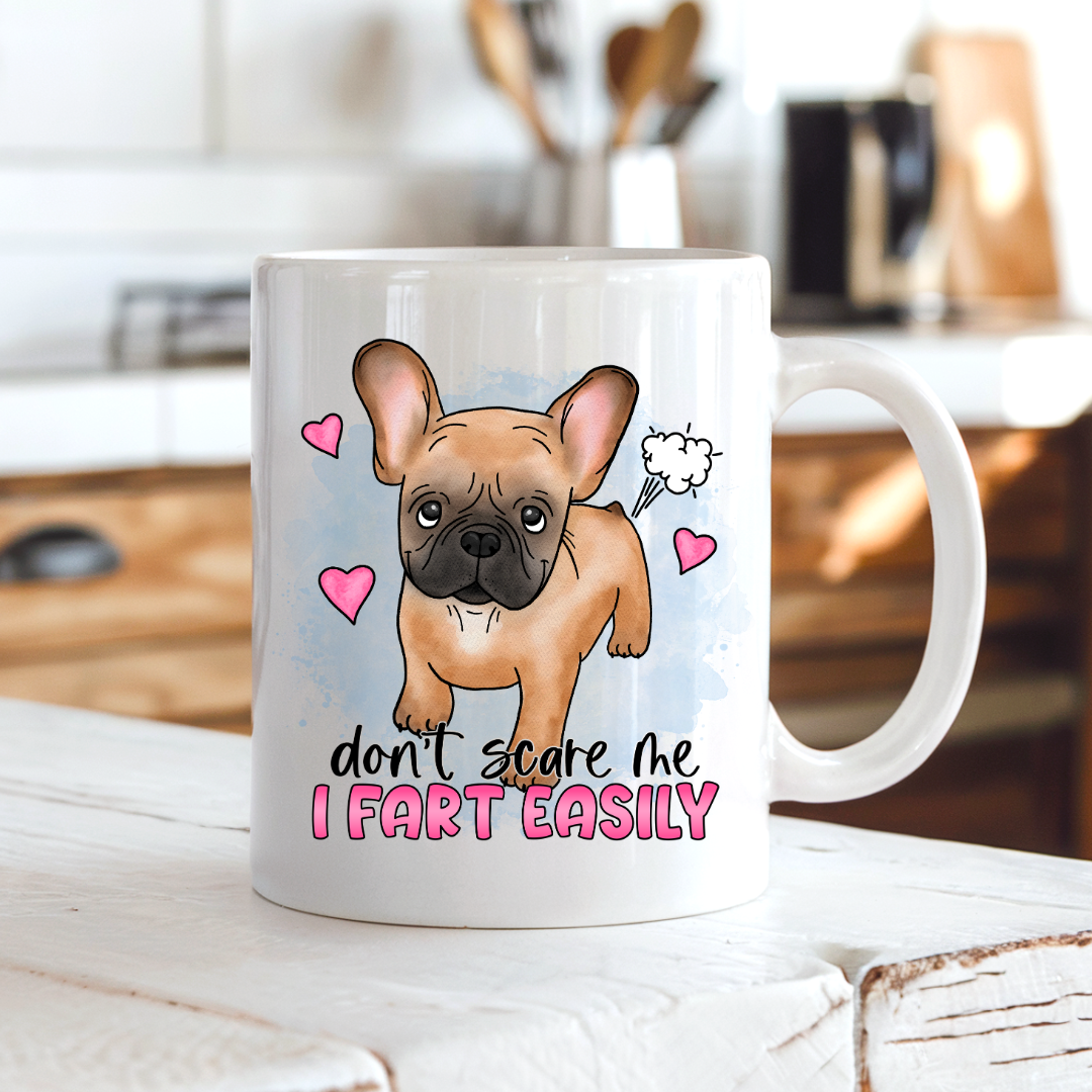 Don’t Scare Me I Fart Easily French Bulldog funny coffee mug on a country kitchen bench, adding humour to a rustic setting, by Coffee and Moo.