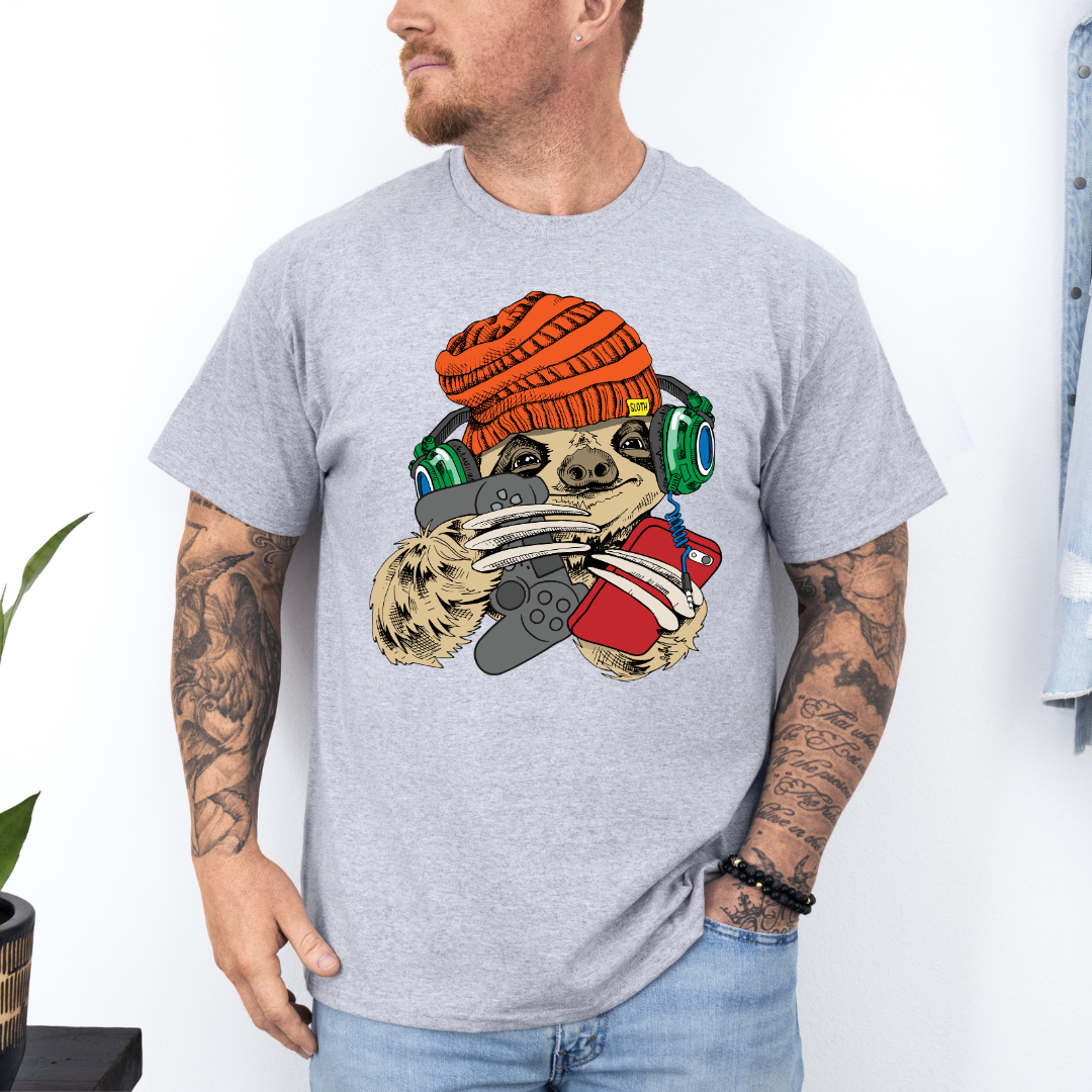 Male Model wearing a grey Gamer Sloth soft graphic t-shirt, showcasing its unique design and comfortable fit from Coffee and Moo.