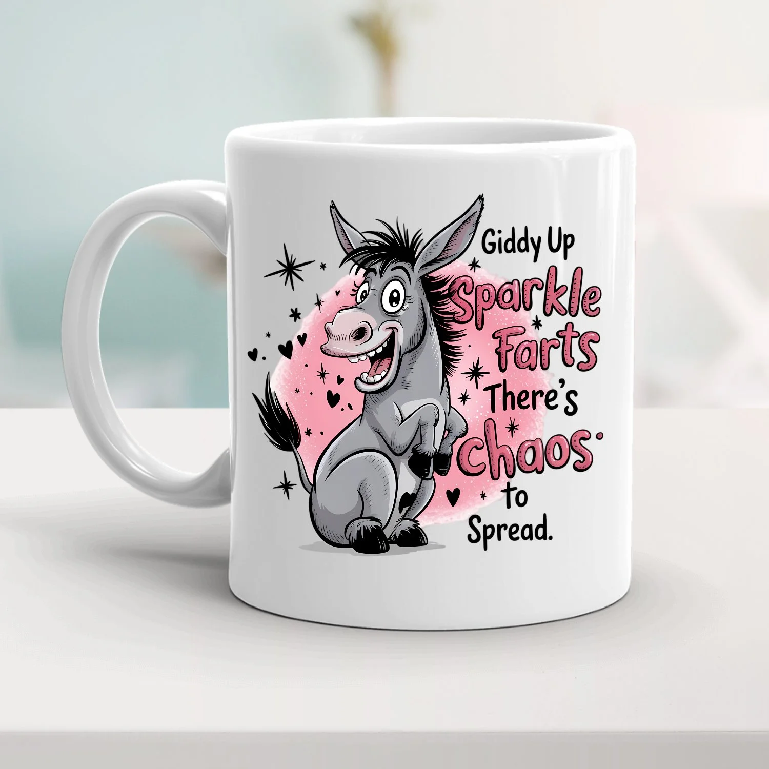 A white mug with a cartoon of a happy donkey. The donkey is standing on its hind legs and smiling. The mug has pink and black text that reads, "Giddy Up Sparkle Farts, There's Chaos to Spread," surrounded by black stars, hearts, and a pink background.