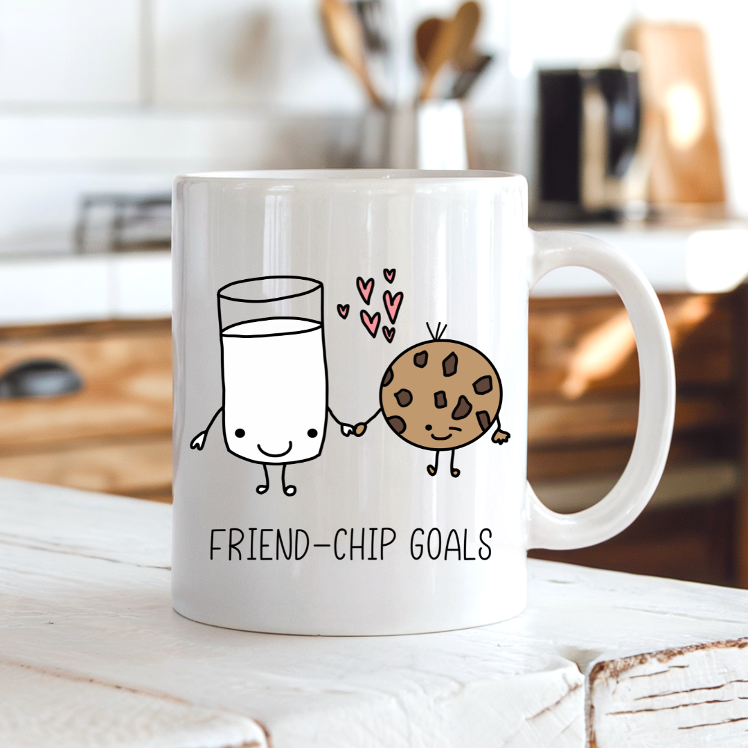 Friend-chip Goals cute coffee mug on a breakfast table, adding a sweet touch to your morning routine, by Coffee and Moo.