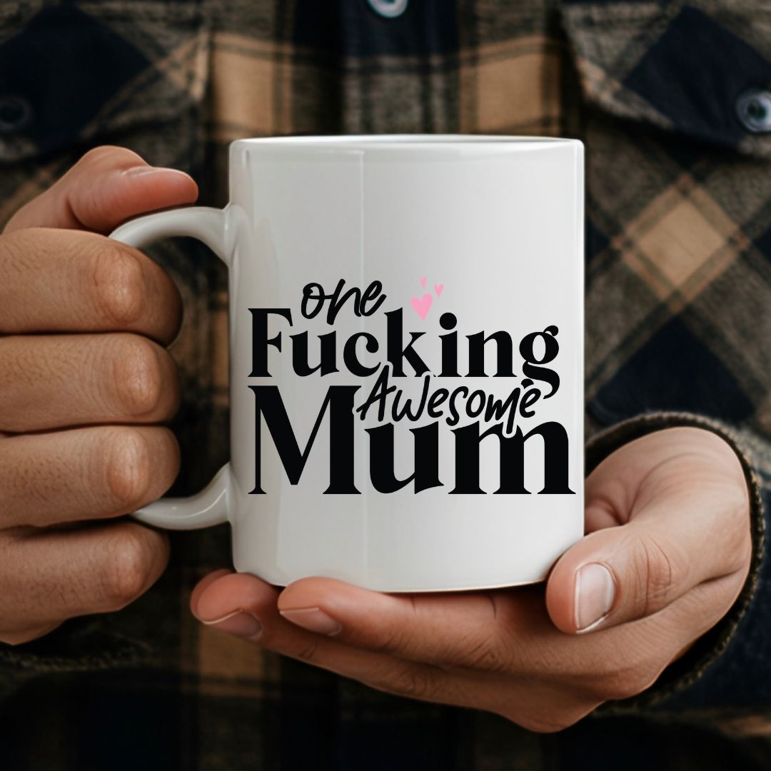person holding One Fucking Awesome Mum humorous coffee mug, showcasing the design and comfortable grip, by Coffee and Moo.