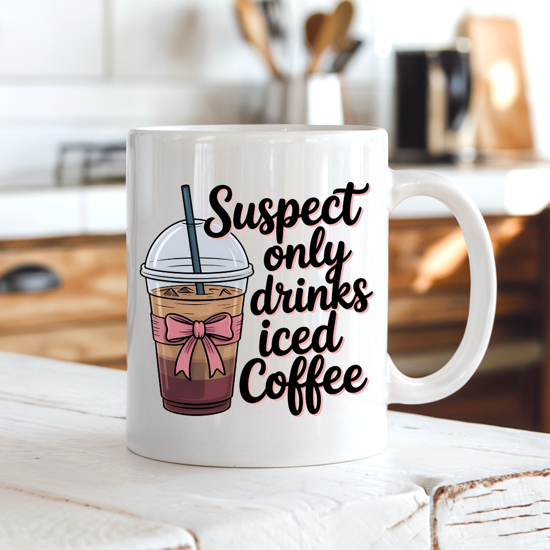 Suspect Only Drinks Iced Coffee funny coffee mug on a country kitchen bench, adding humour to a rustic setting, by Coffee and Moo.