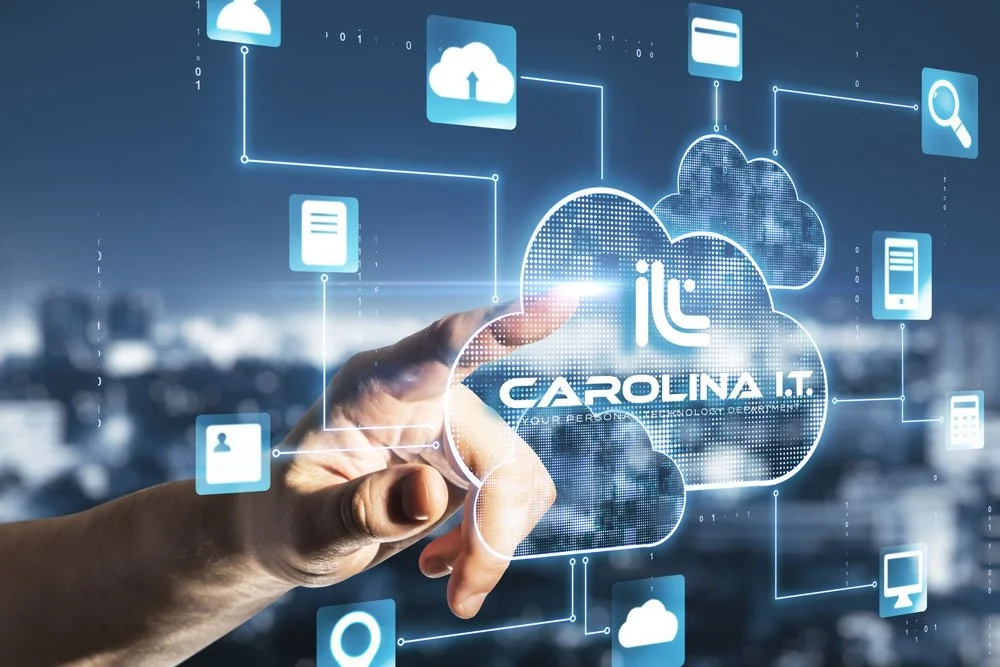 Hand touching a digital cloud icon with the text "Carolina I.T." surrounded by various digital icons representing cloud storage, user profiles, data, search, and mobile devices, on a blue background.