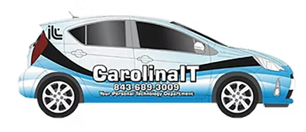 Side view of a car with a wrapped advertisement for CarolinaIT, including contact number 843-689-3009 and tagline 'Your Professional Technology Deployment'.