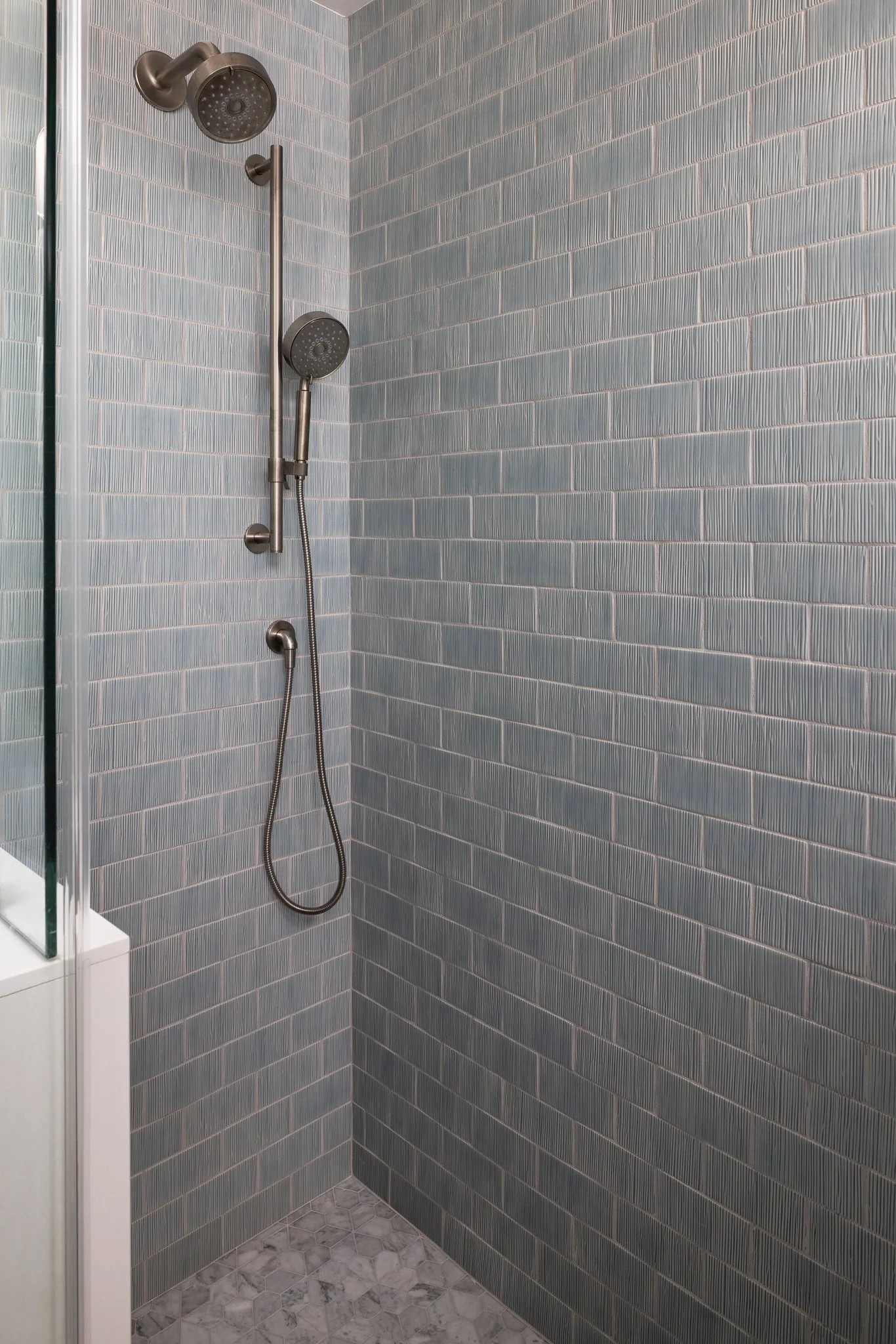 light blue textured tile shower
