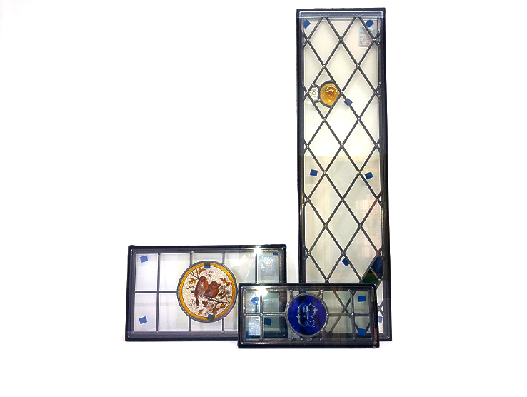 Three rectangular glass-topped board games with colorful tokens inside, arranged on a white background.