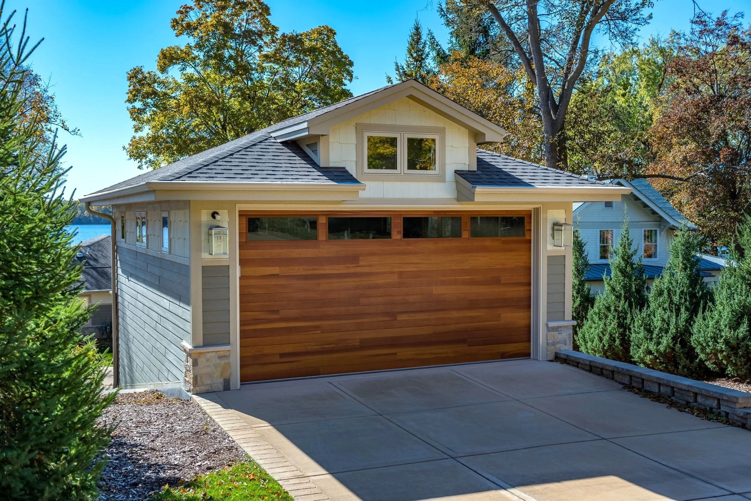 Plank Garage Door with Windows on Lakeside House