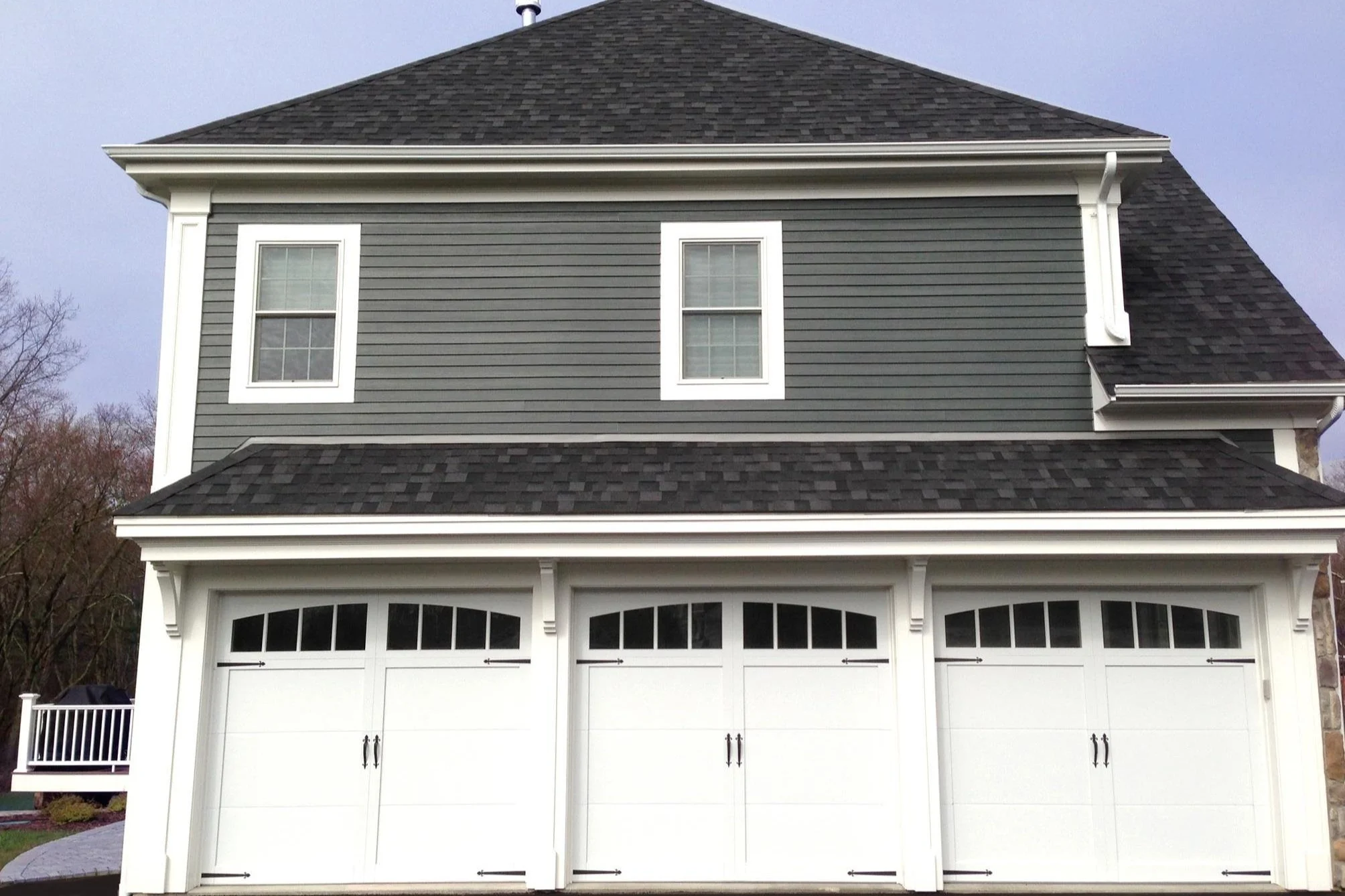 Three Carriage Collection Garage Doors on Two Story House