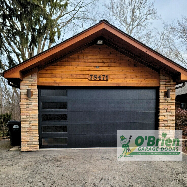 Black Skyline Garage Door on Wooden House with Windows