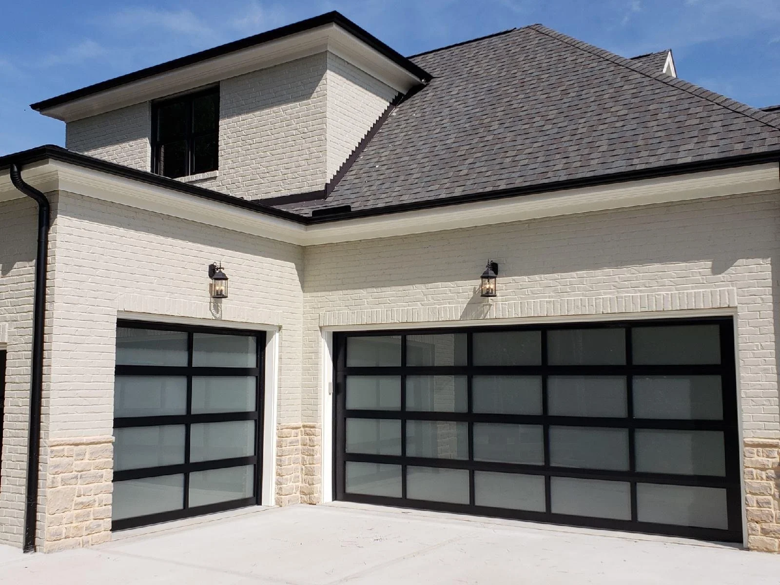 Two Alternate Sized Full View Garage Doors