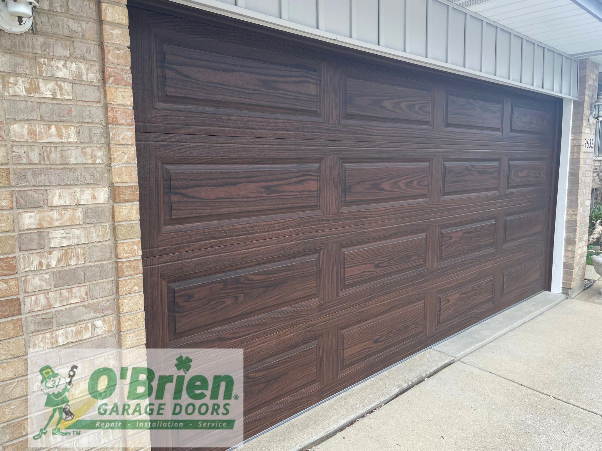 Long Raised Panel Garage Door Steel Back Insulated in Accent Wood Tone Dark Oak no Windows