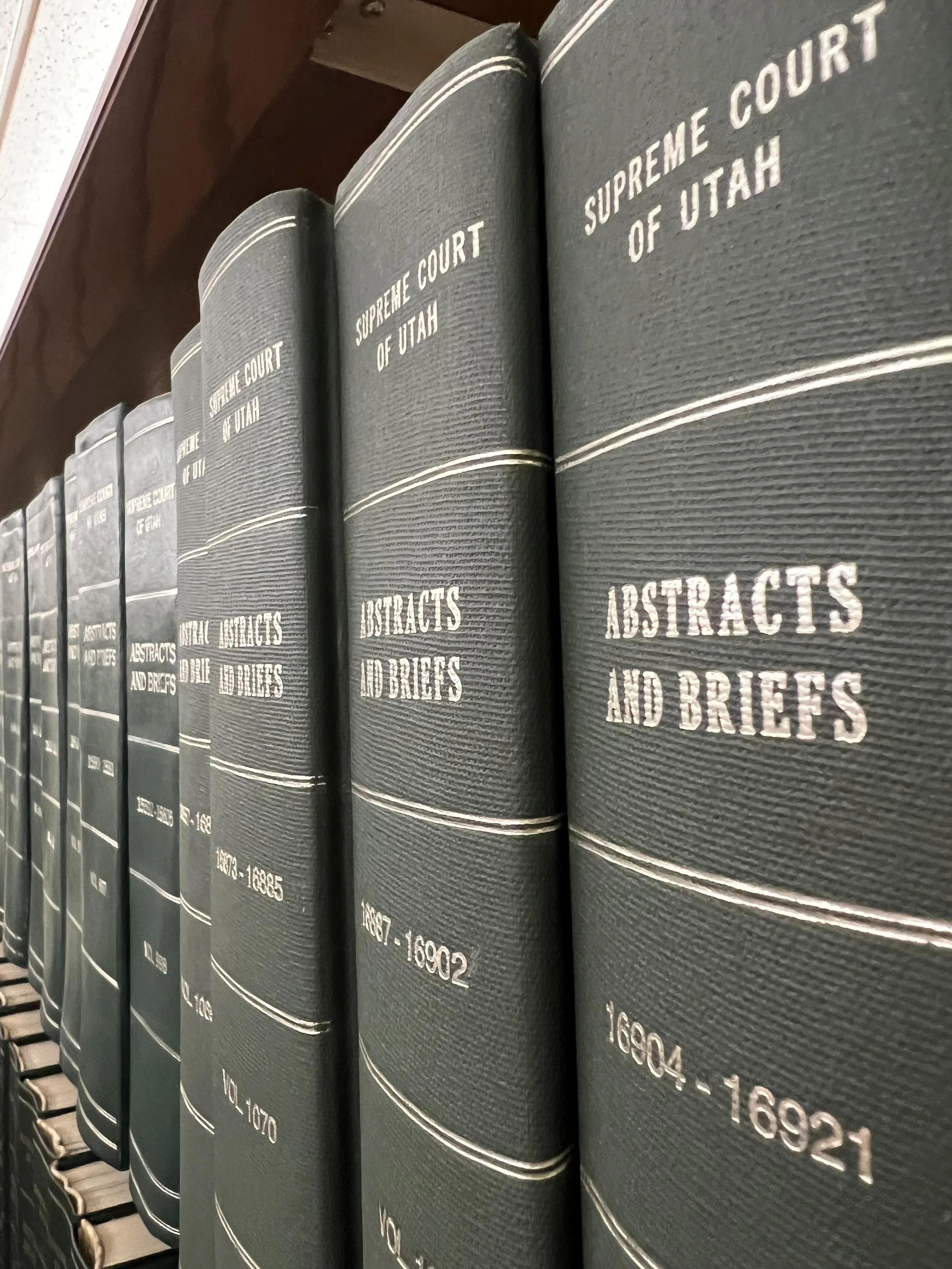 Shelf of legal books titled 'Supreme Court of Utah' and 'Abstracts and Briefs'.