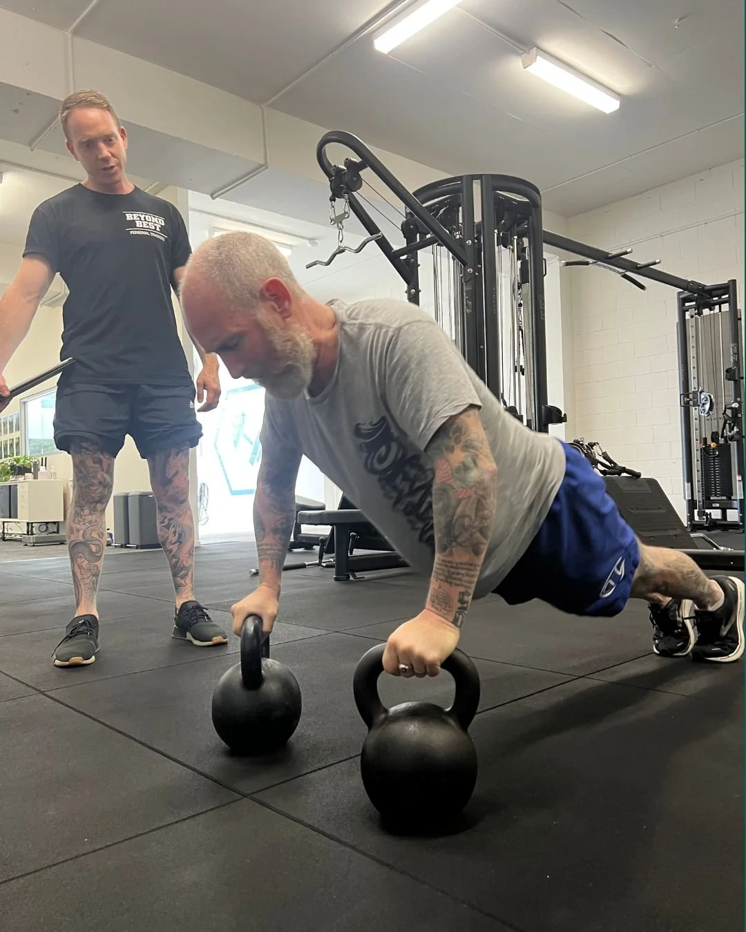 Collingwood personal trainer coaching a client through a kettlebell strength exercise at Beyond Best.