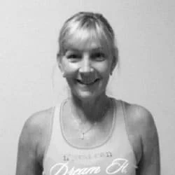 Silhouette of a person with backlight creating a halo effect around their head and shoulders against a dark background.