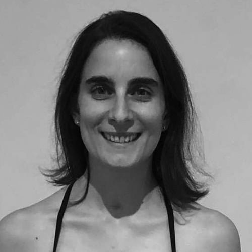 Silhouette of a person with backlit hair and shoulders in a dark setting.