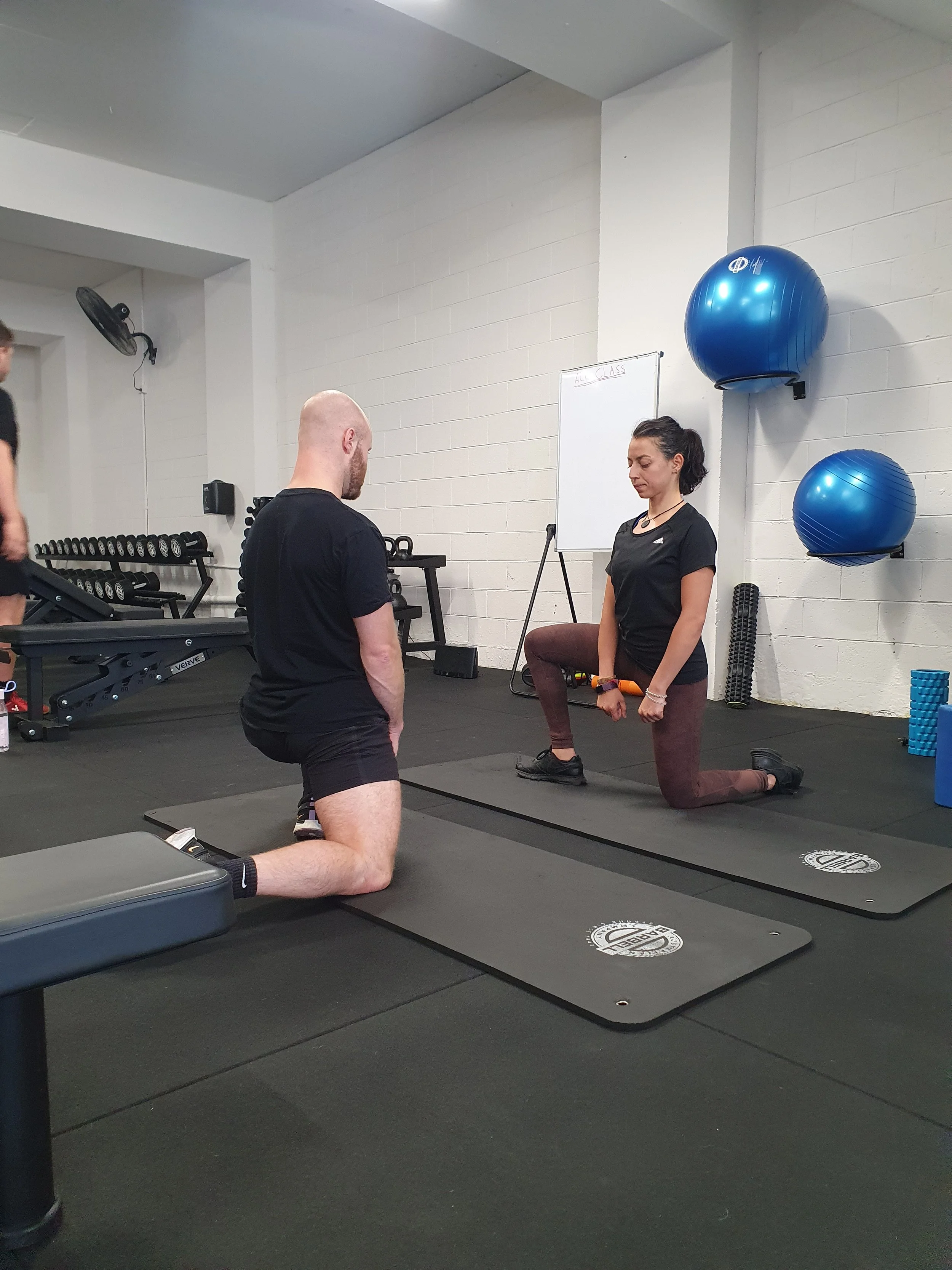 An avocado wrapped in a measuring tape on a pink background.
