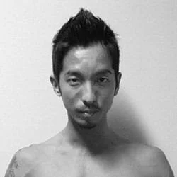 Silhouette of a person with backlit hair and ears, dark background.