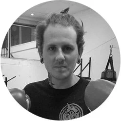 Backlit silhouette of a person's head and shoulders against a black background.