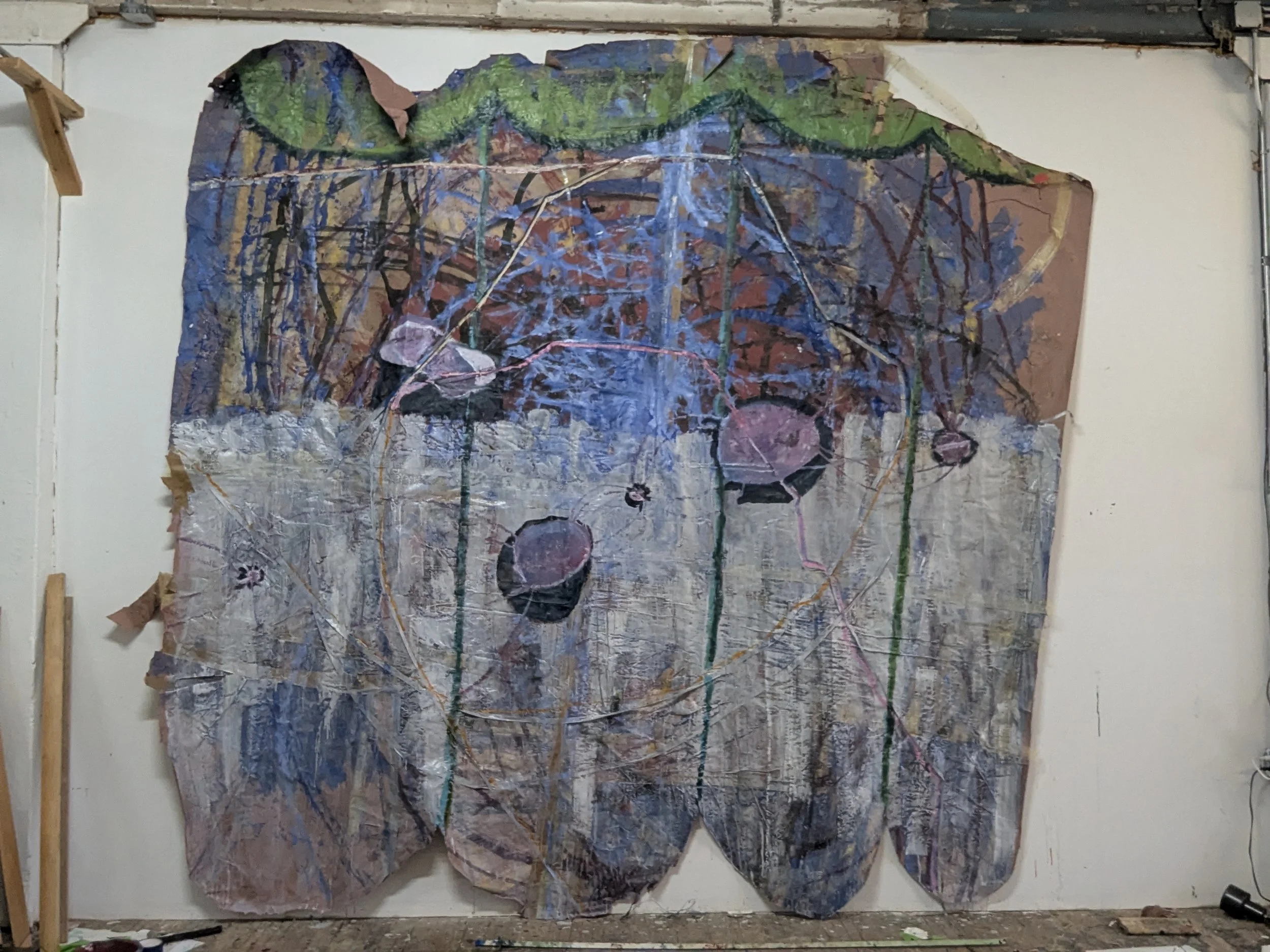Abstract mixed media artwork on large paper or canvas, featuring vibrant colors, lines, and textures with visible crumples and folds, mounted on a wall with wooden supports.