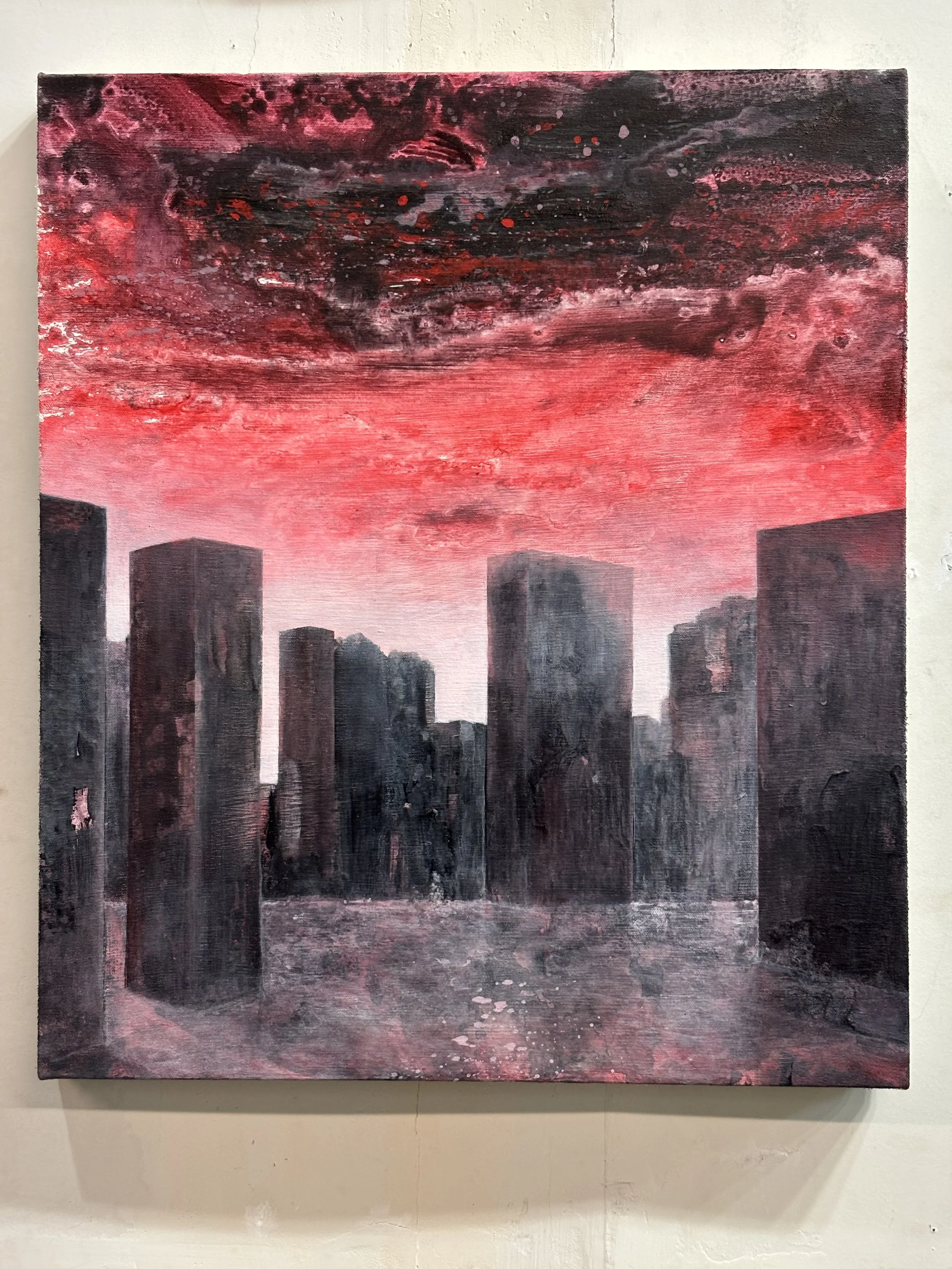 A painting depicting a city skyline with dark, abstract buildings below a vivid, turbulent sky filled with red and black hues and swirling patterns.