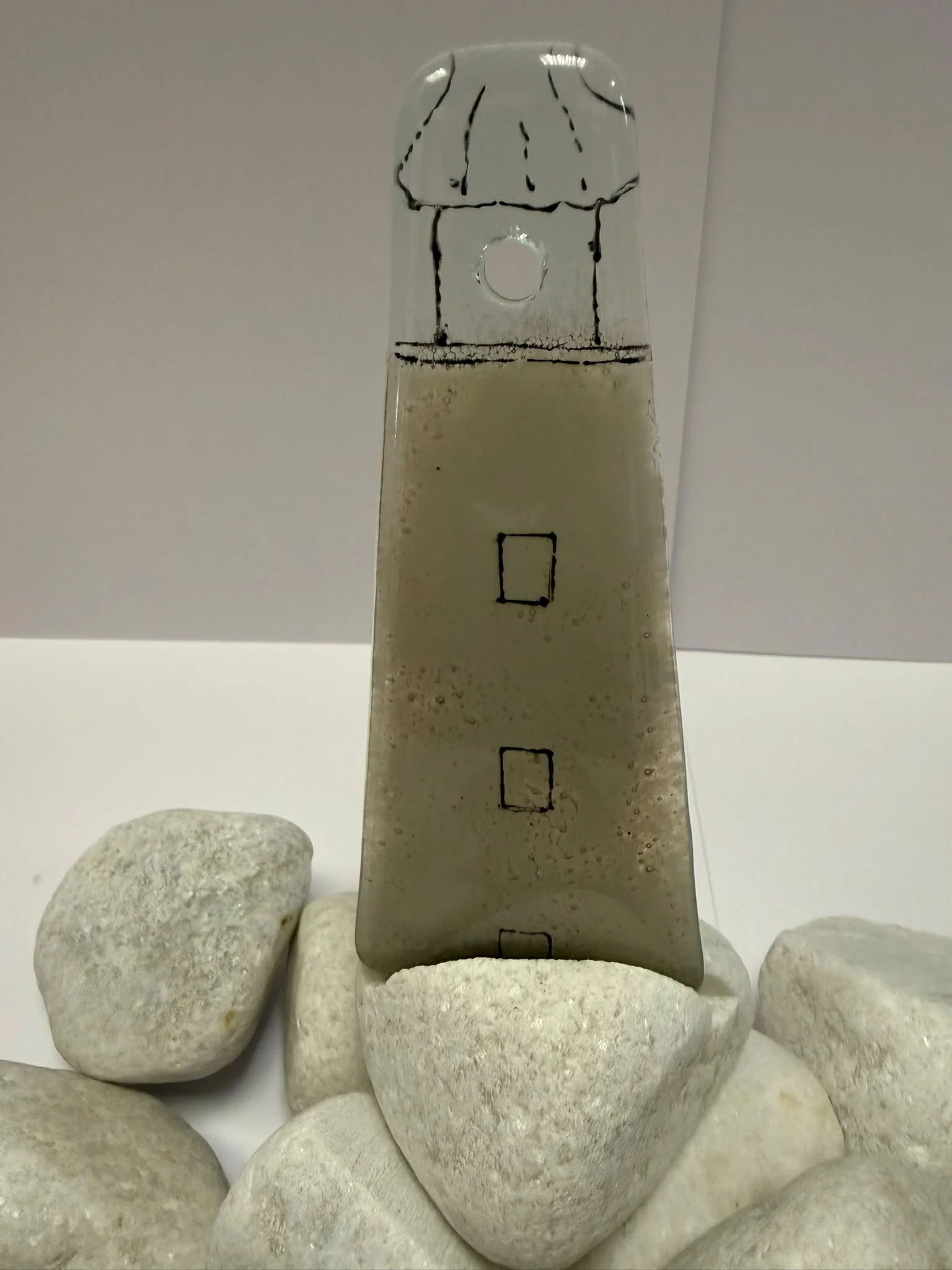 White lighthouse on a coble stone x 1