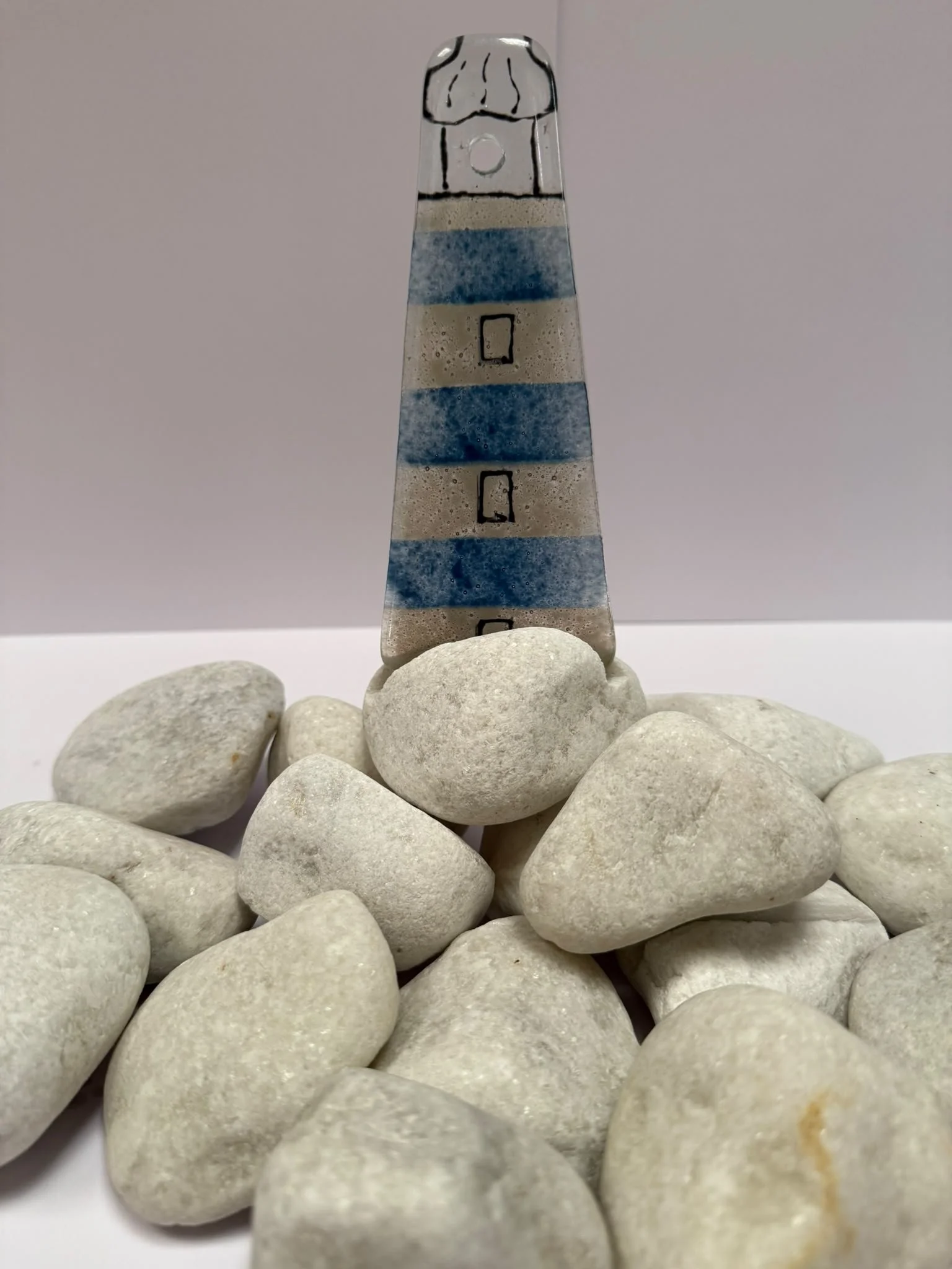 Blue lighthouse on a coble stone x 1