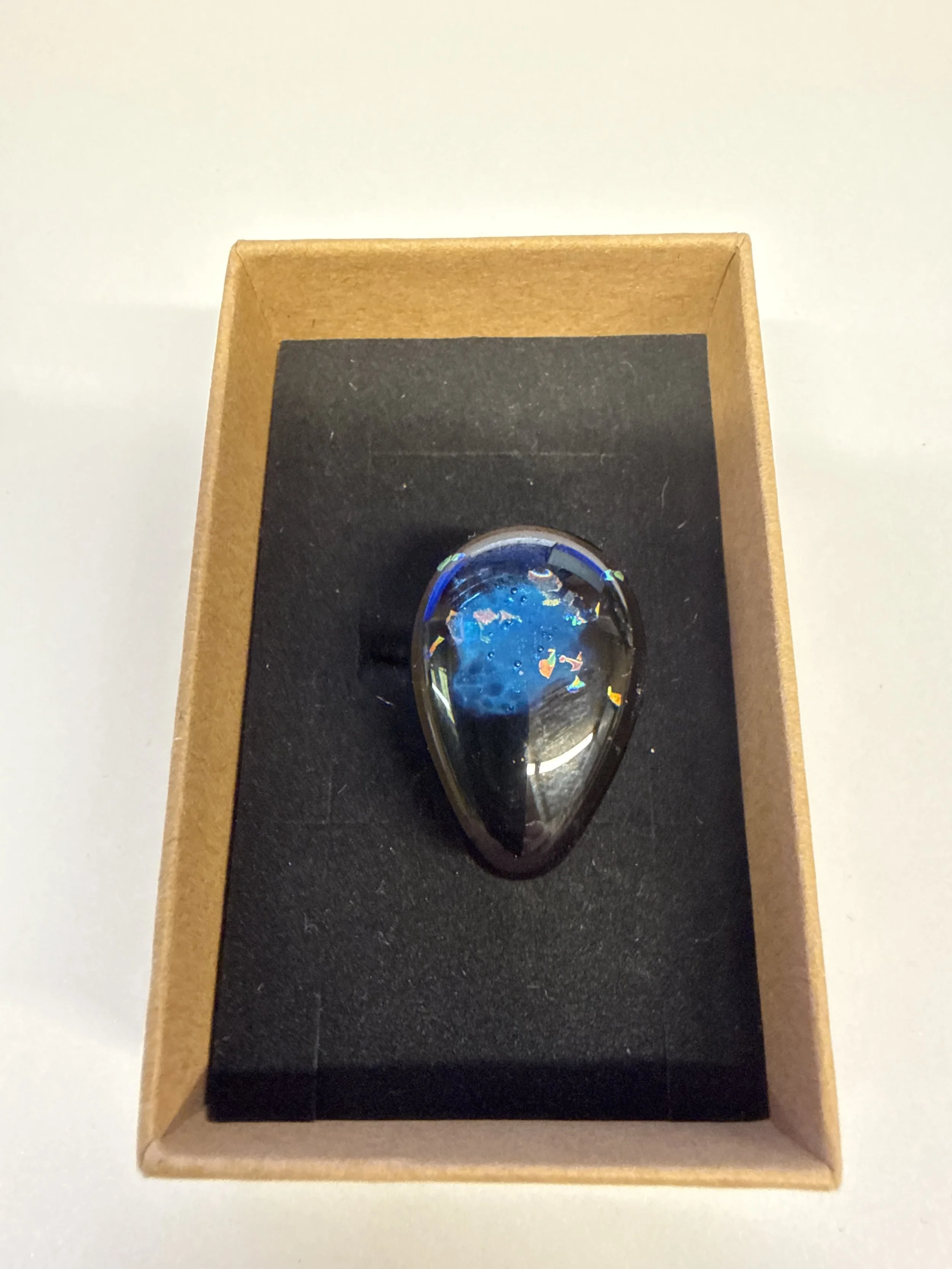 Teardrop shape black with blue centre