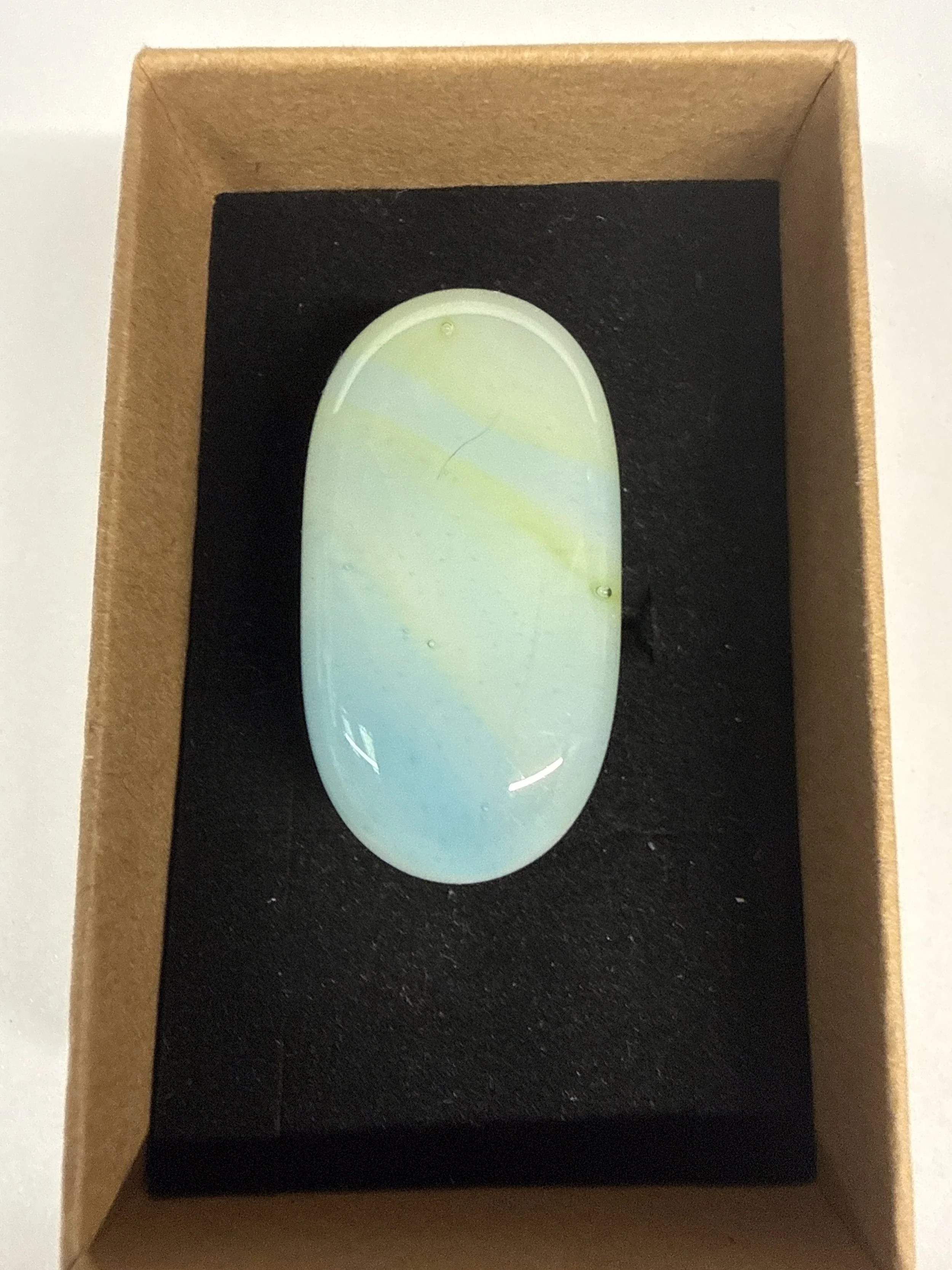 Oval shape ring white yellow green hue