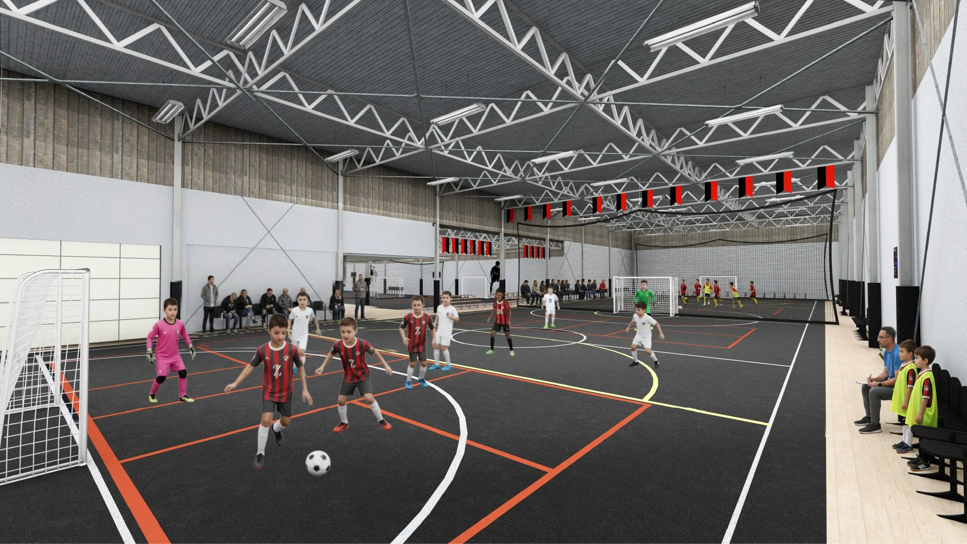 Indoor sports facility with children playing indoor soccer or futsal, some children wearing yellow bibs, cheering on the game, and spectators seated on benches along the wall.