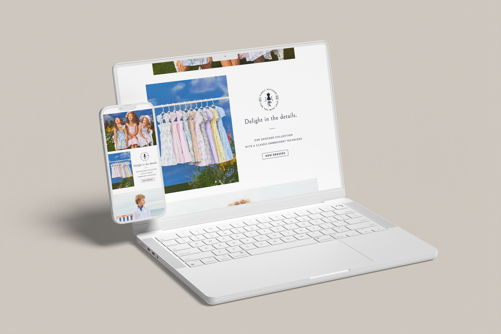 A white laptop and smartphone displaying a website for a children’s clothing brand featuring dresses and children, with a beige background.