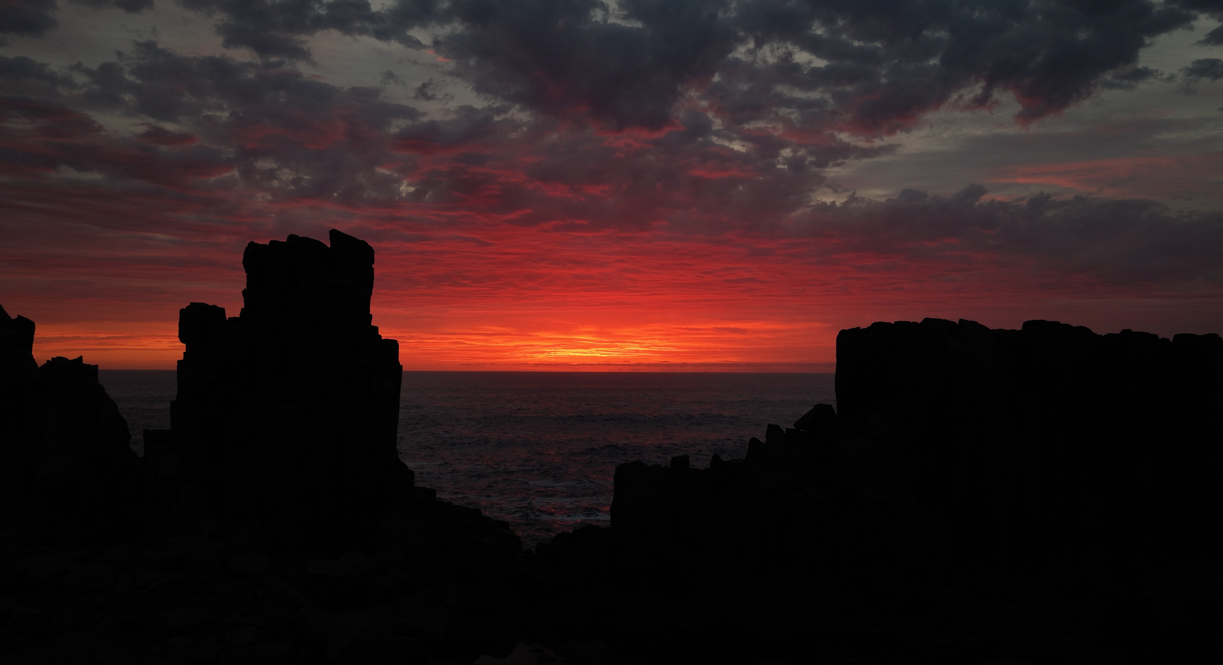 Cinematic ocean sunrise over coastal rock formations filmed by Sydney cinematographer for documentary and tourism content