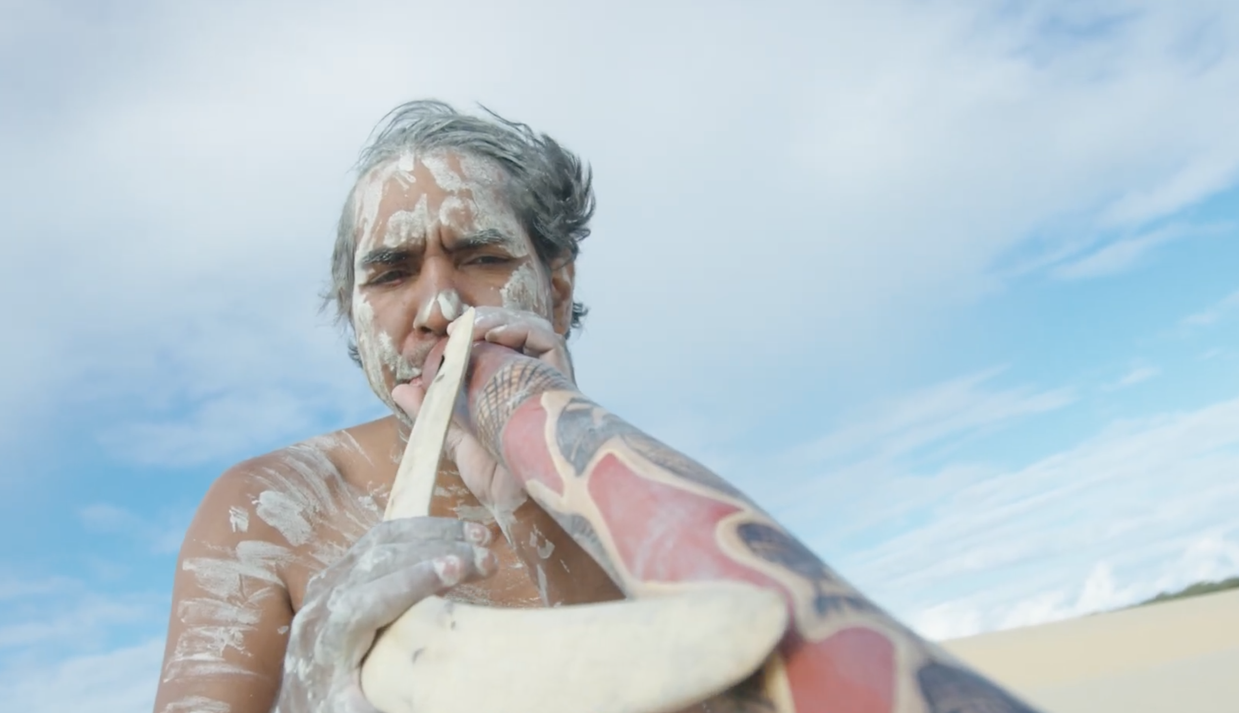 Local aboriginal musician performing traditional instrument filmed for documentary cinematography