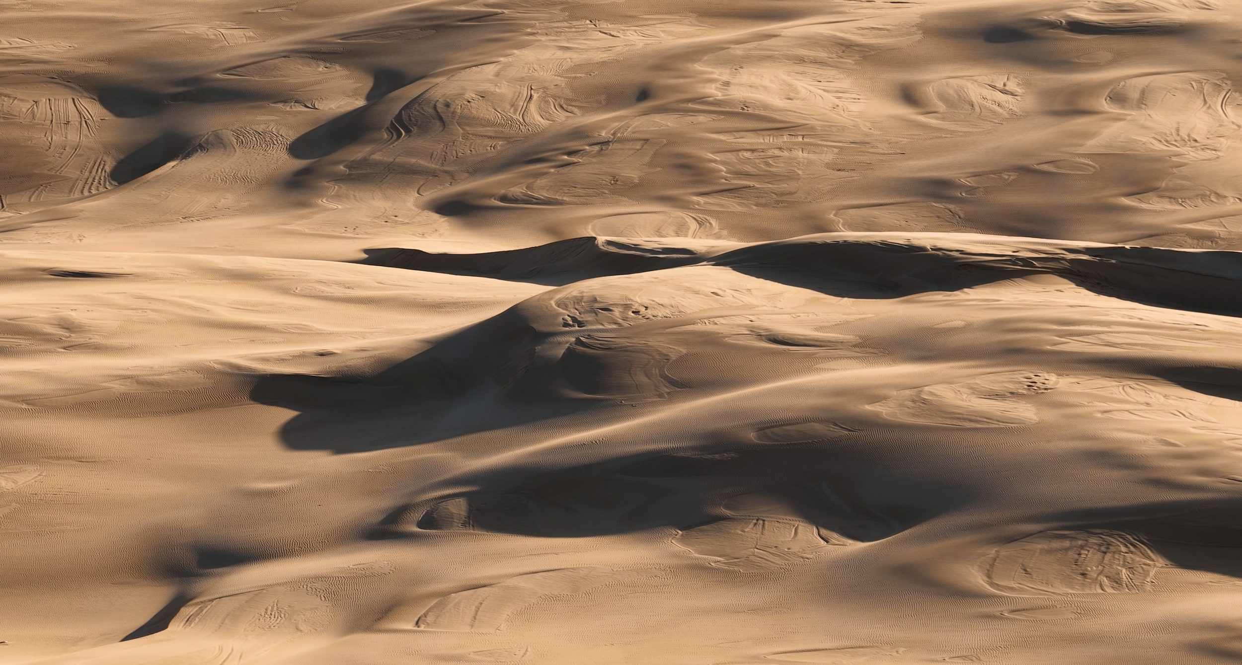 Aerial view of textured sand dunes in Australia captured for cinematic travel and commercial video production